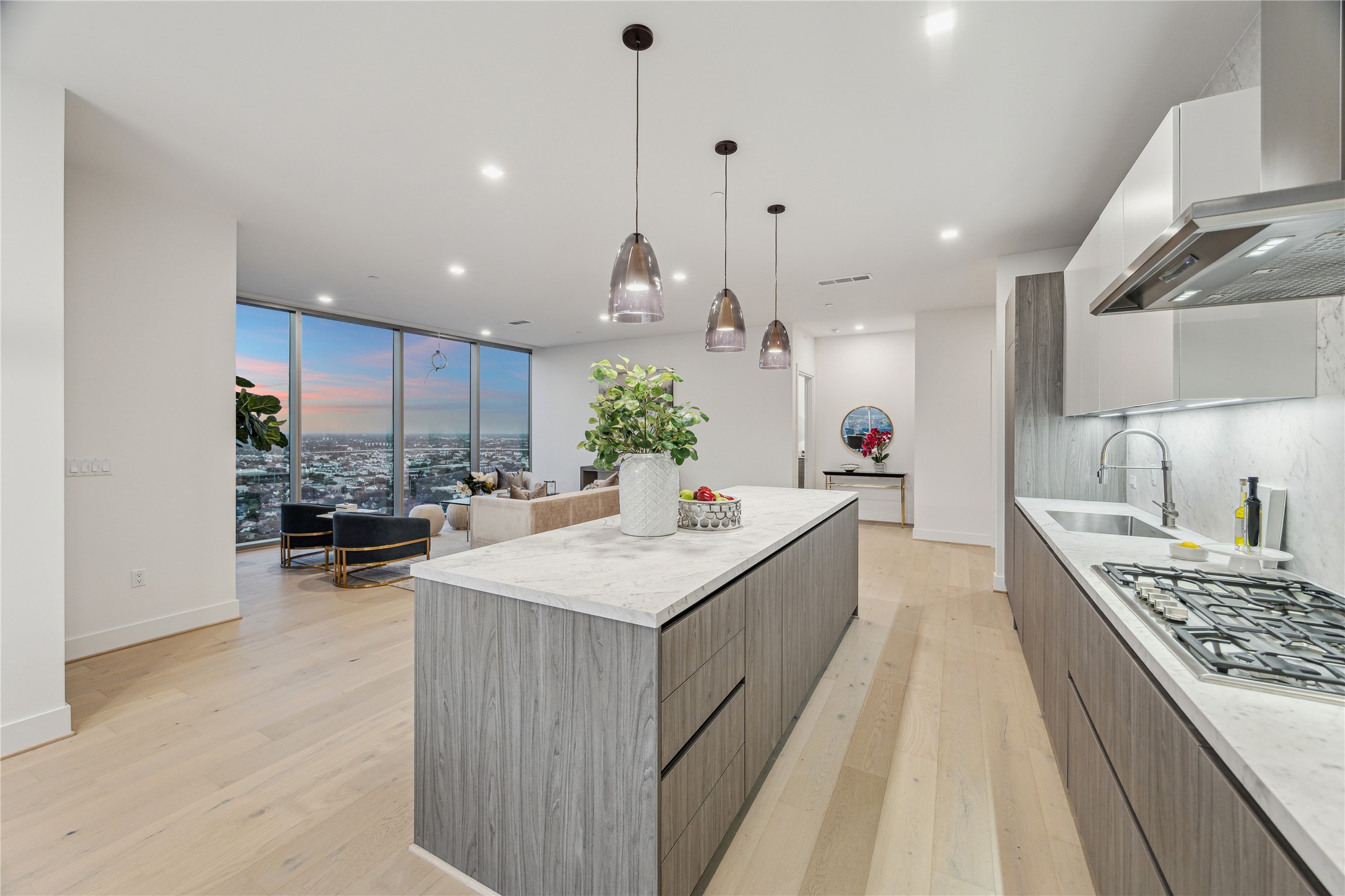 1711 Allen Parkway, Unit 2301 Houston, TX 77019 - Photo 11 of 45 a large kitchen with stainless steel appliances kitchen island granite countertop a lot of counter space and a chandelier