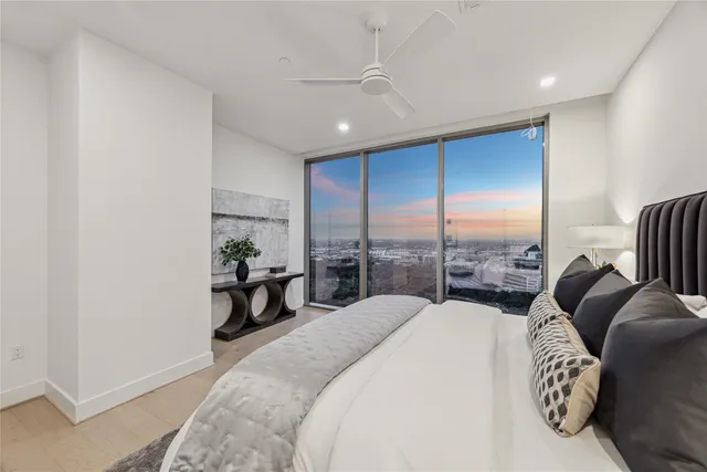 a bed room with a bed and a large window