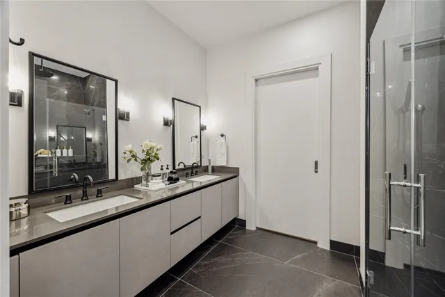 a bathroom with a double vanity sink and mirror