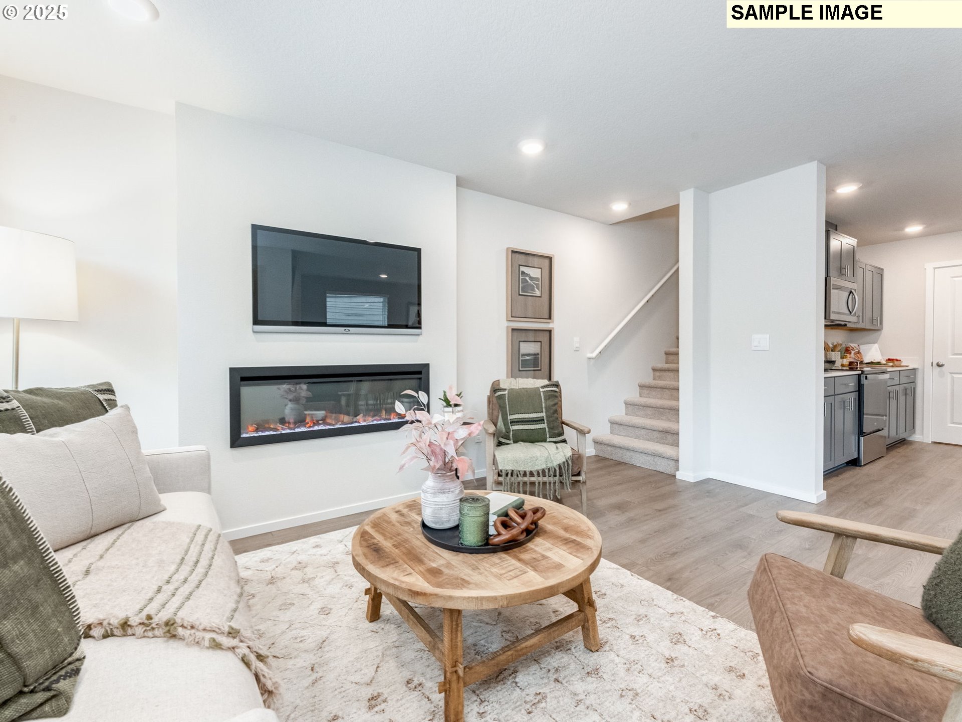 1105 Southeast 194th Place Camas, WA 98607 - Photo 11 of 26 a living room with furniture a flat screen tv and a fireplace