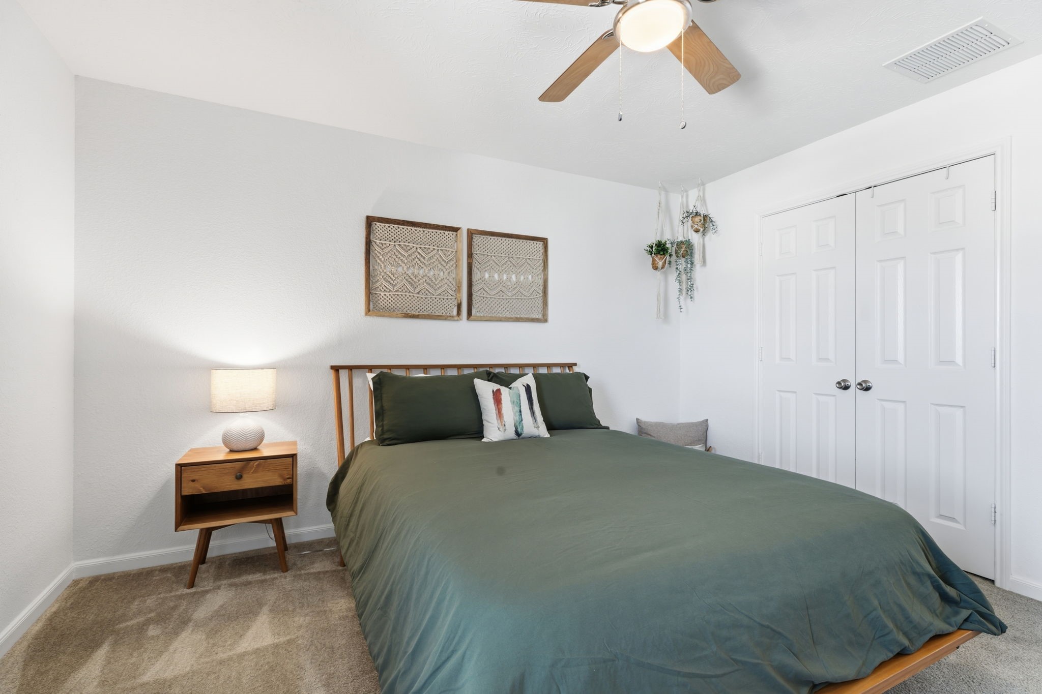 5127 Avondale Rise Street Katy, TX 77493 - Photo 33 of 47 a bedroom with a bed and a chandelier