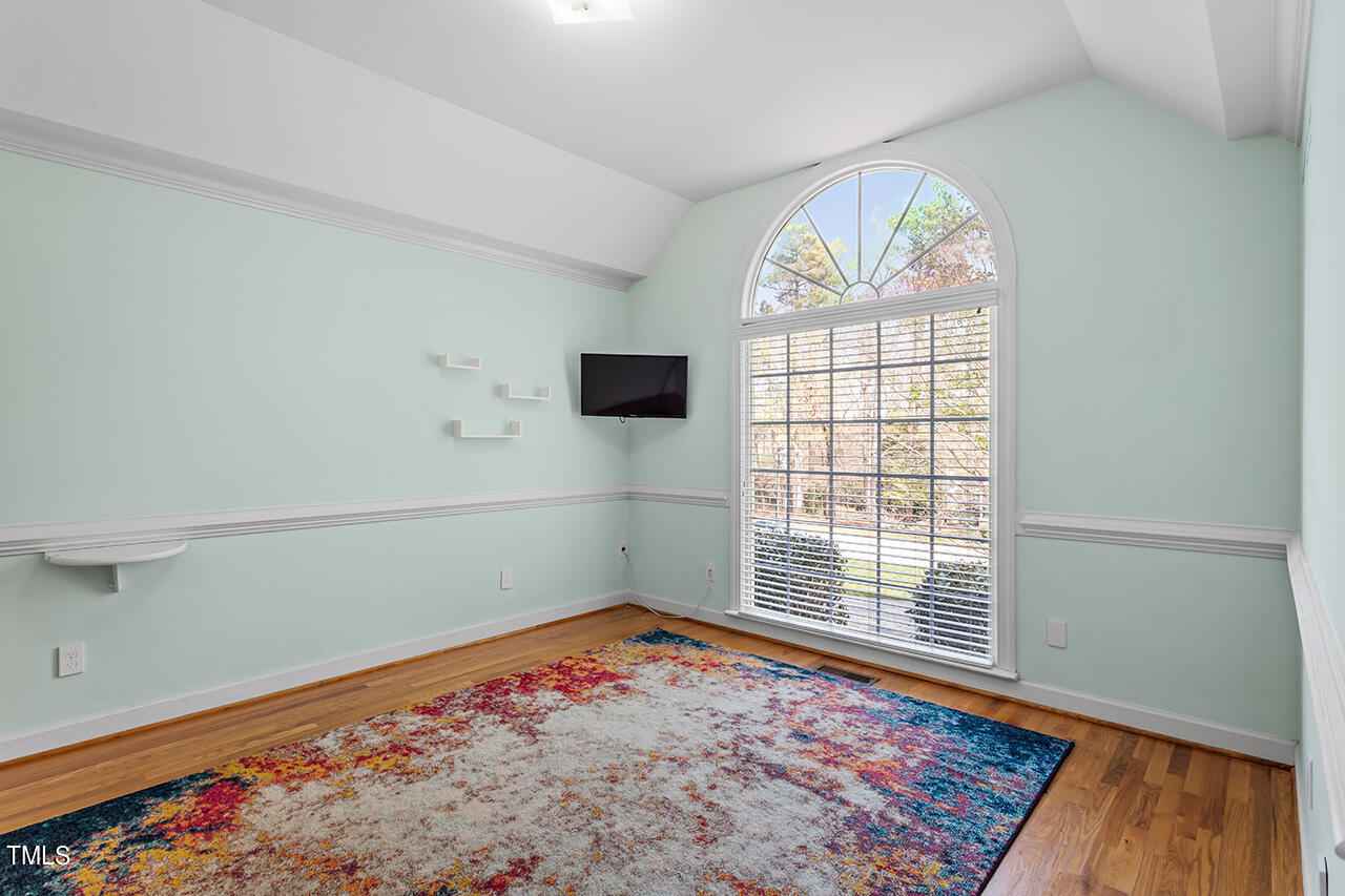 7917 Fairlake Drive Wake Forest, NC 27587 - Photo 13 of 34 an empty room with wooden floor and windows
