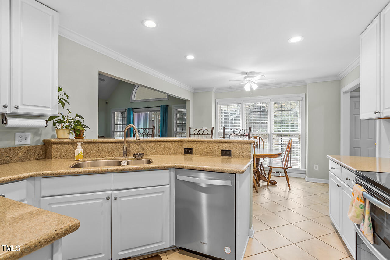 7917 Fairlake Drive Wake Forest, NC 27587 - Photo 15 of 34 a kitchen with a sink and chairs