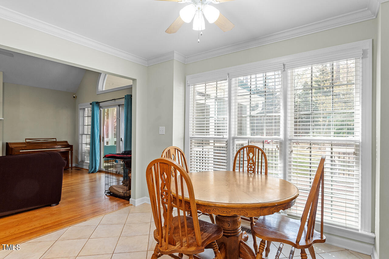 7917 Fairlake Drive Wake Forest, NC 27587 - Photo 18 of 34 a dining room with furniture and wooden floor
