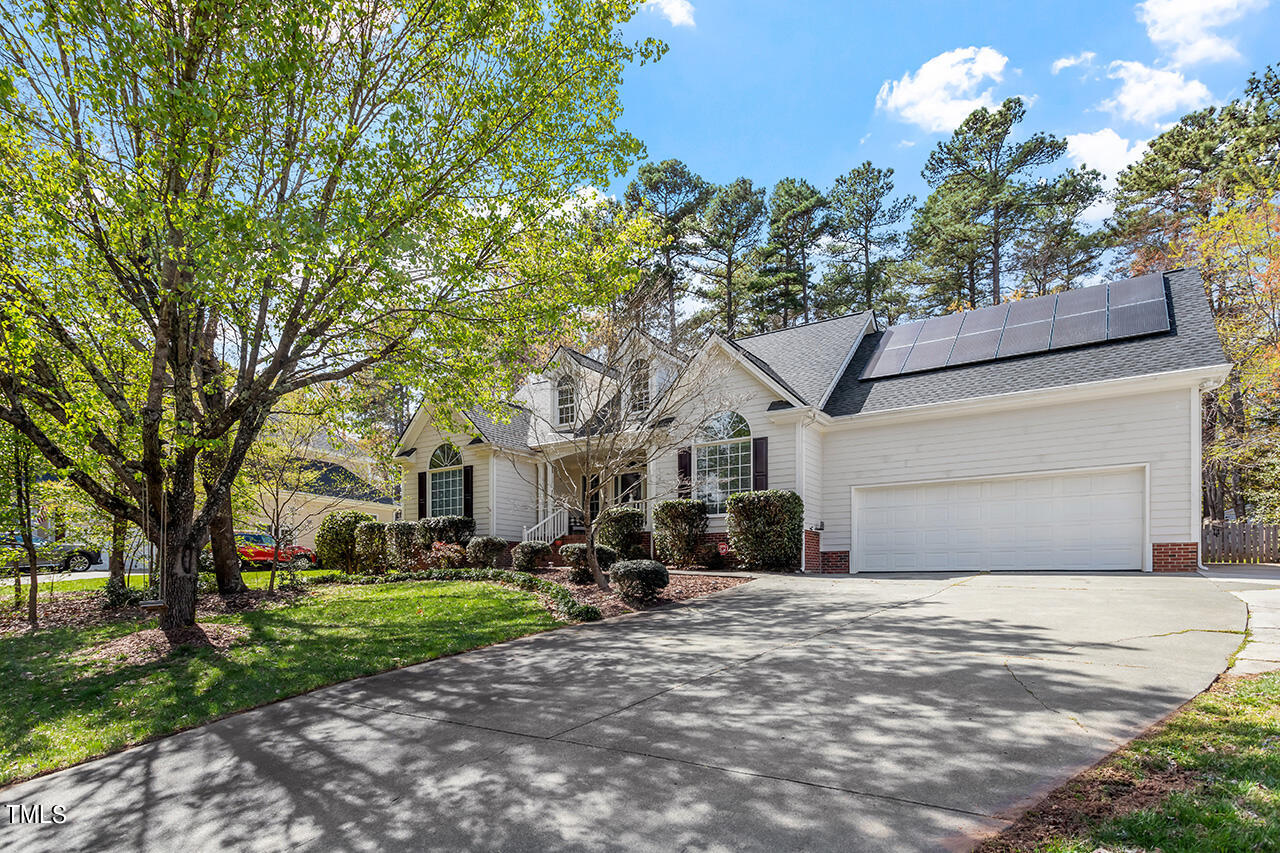 7917 Fairlake Drive Wake Forest, NC 27587 - Photo 2 of 34 a front view of a house with a yard and garage