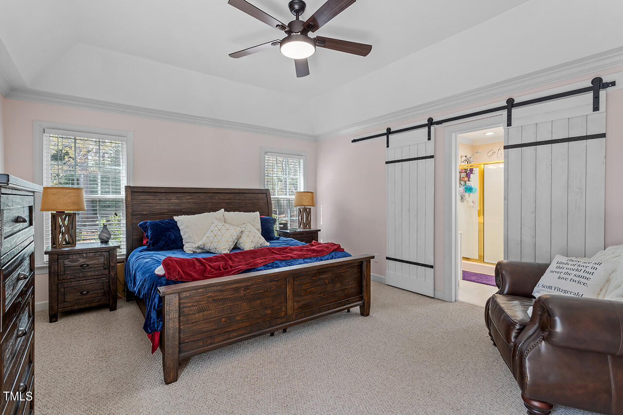 7917 Fairlake Drive Wake Forest, NC 27587 - Photo 22 of 34 a bedroom with a bed dresser and a window