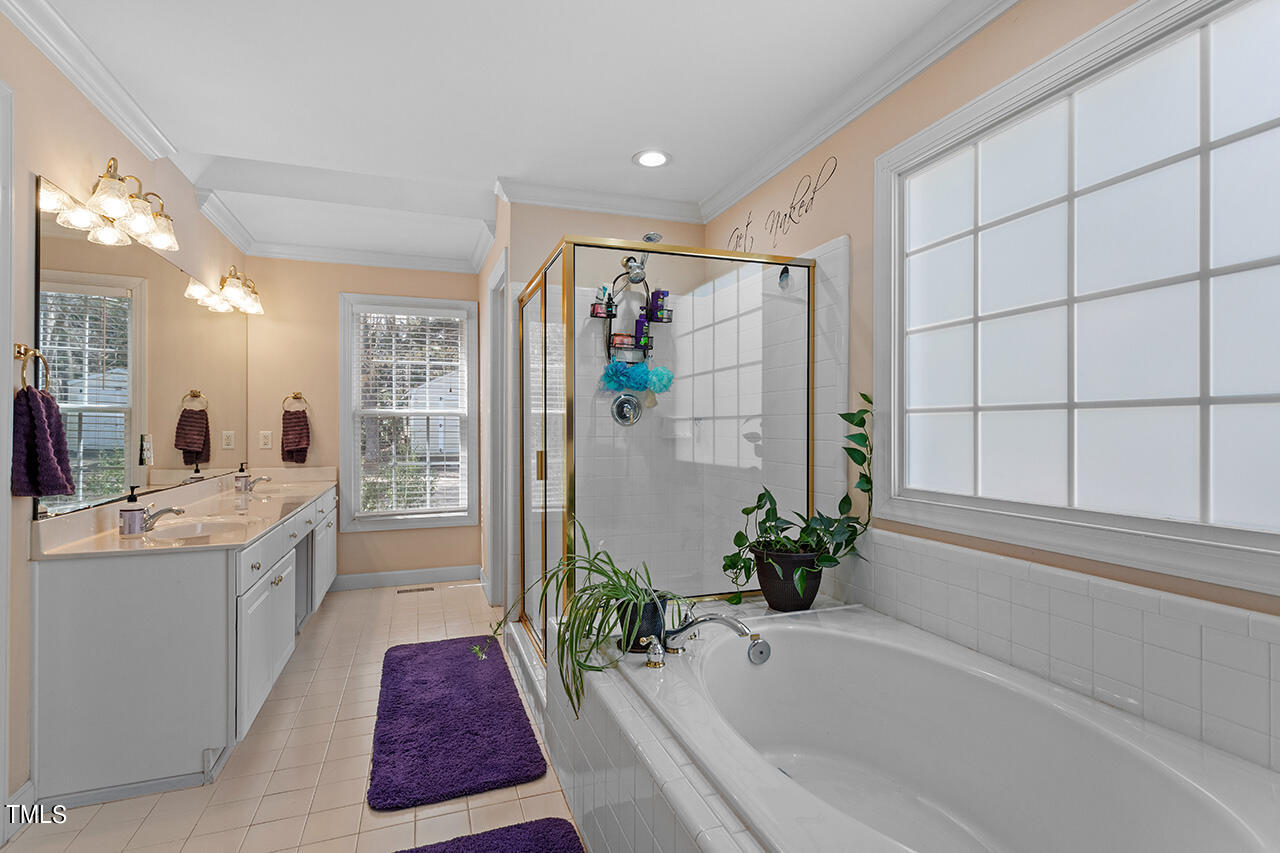 7917 Fairlake Drive Wake Forest, NC 27587 - Photo 25 of 34 a bathroom with a bathtub and a sink