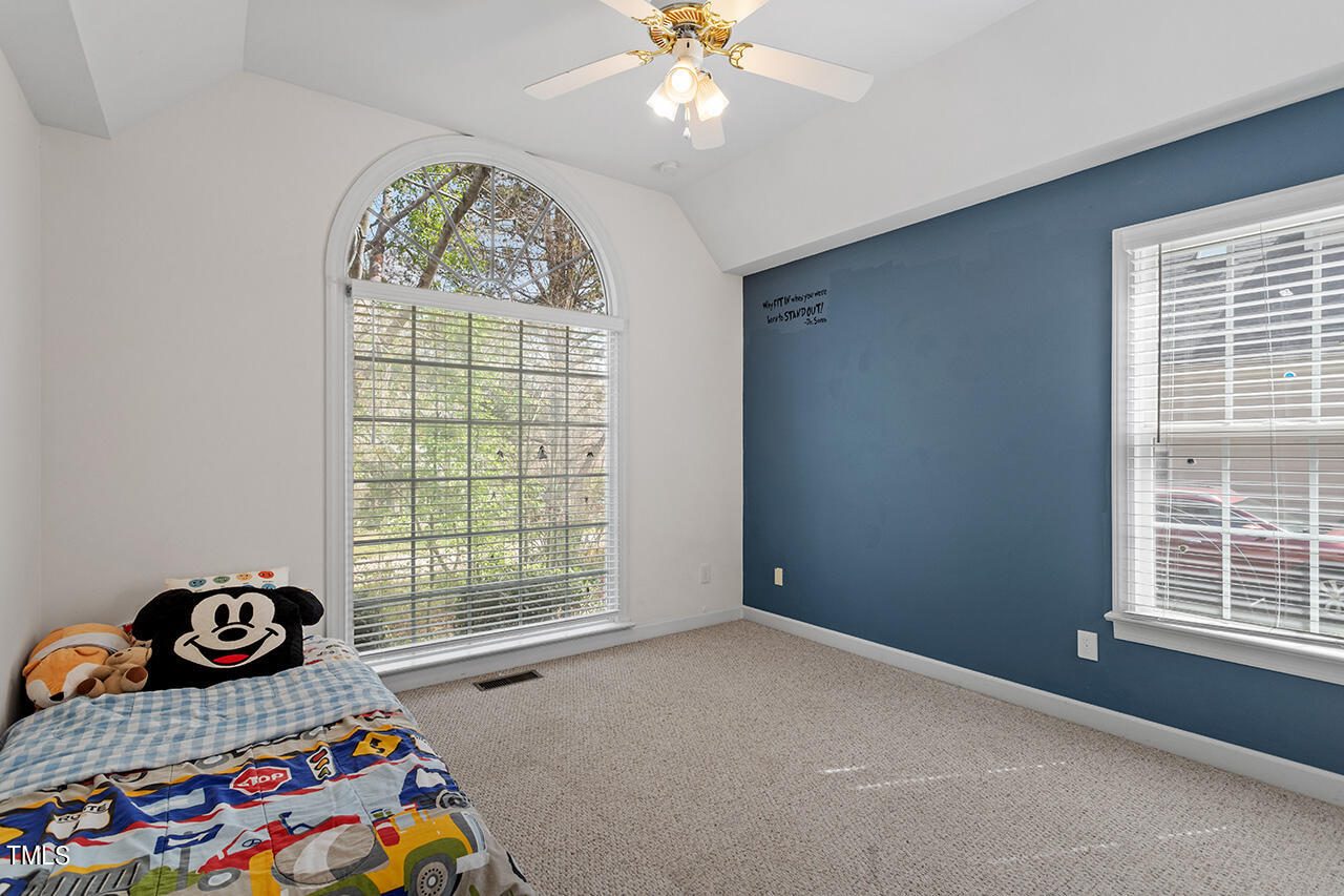 7917 Fairlake Drive Wake Forest, NC 27587 - Photo 27 of 34 a bedroom with a bed and a window