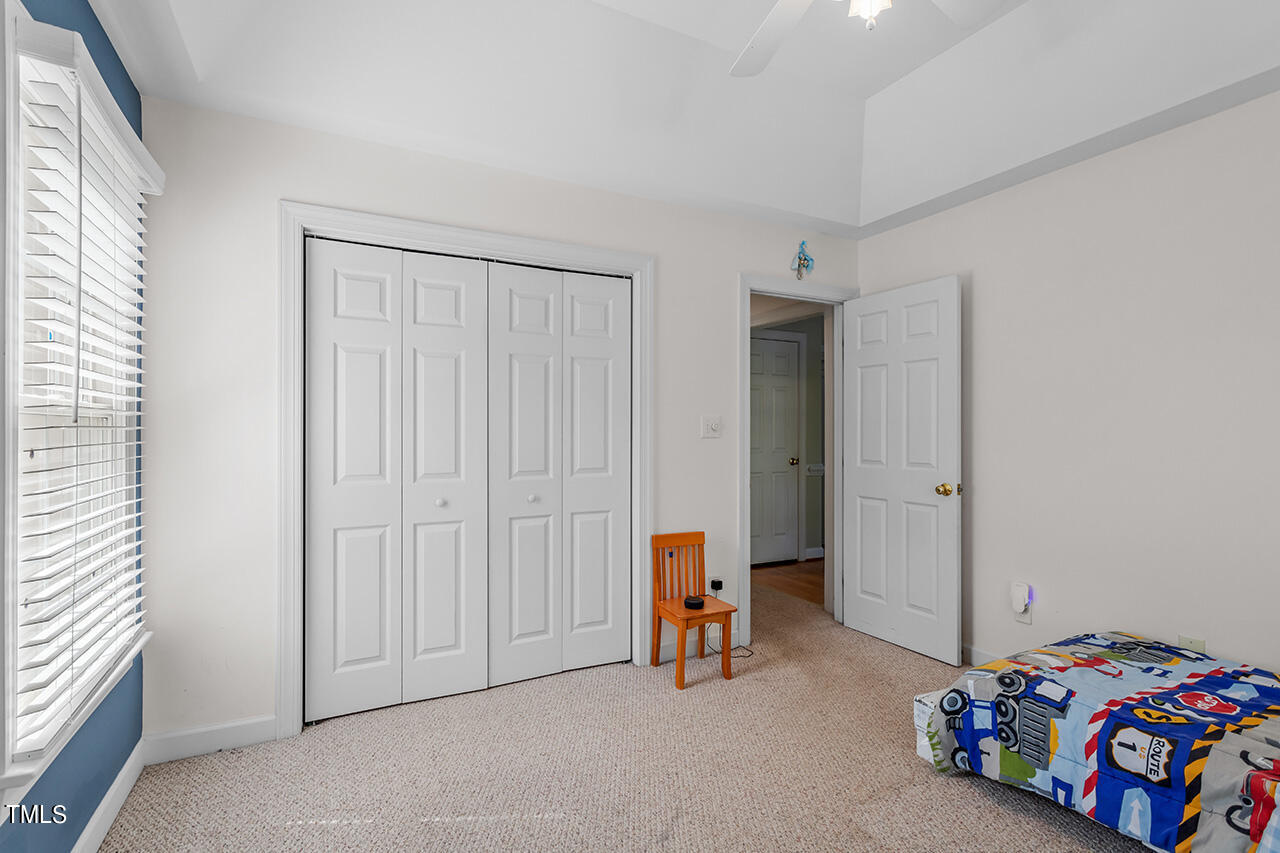 7917 Fairlake Drive Wake Forest, NC 27587 - Photo 28 of 34 a bedroom with a bed and a window