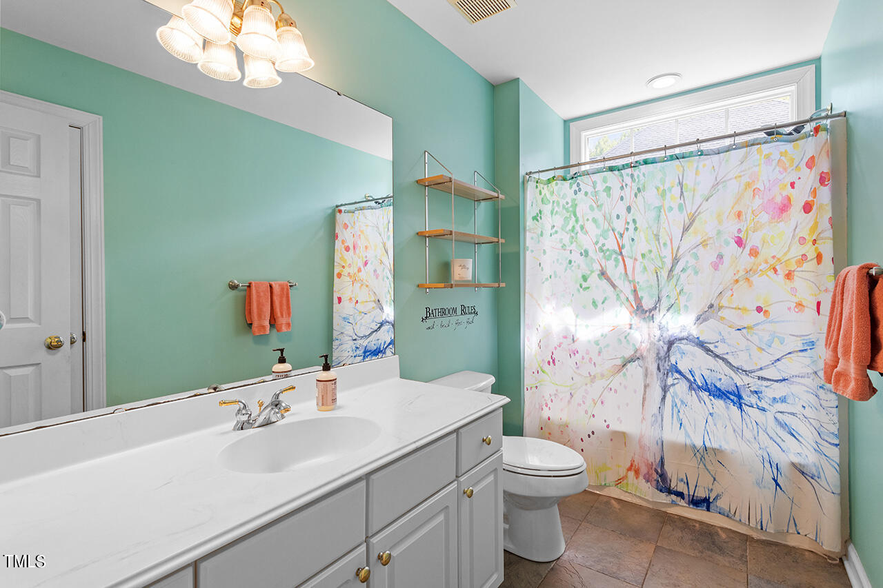 7917 Fairlake Drive Wake Forest, NC 27587 - Photo 29 of 34 a bathroom with a sink vanity mirror and toilet