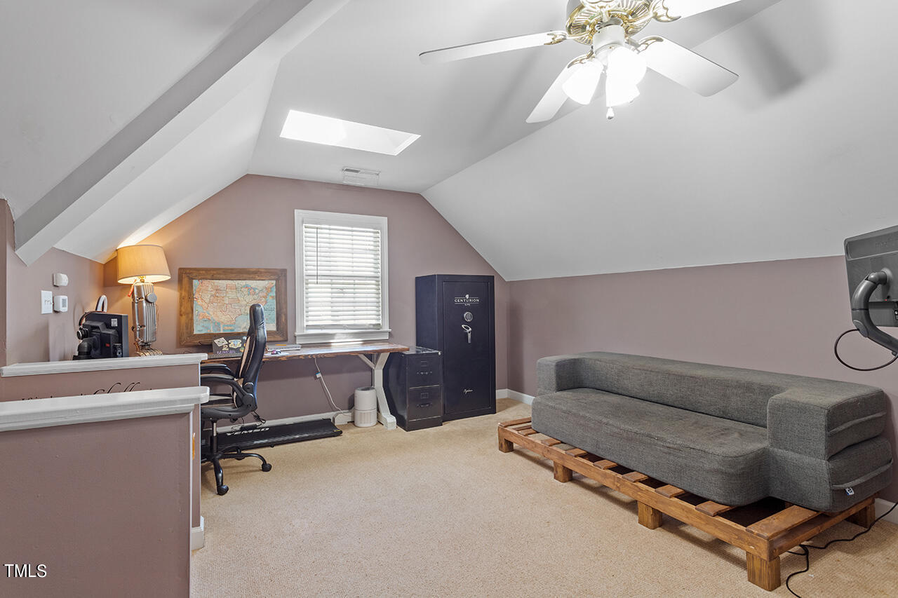 7917 Fairlake Drive Wake Forest, NC 27587 - Photo 32 of 34 a living room with furniture and a chandelier