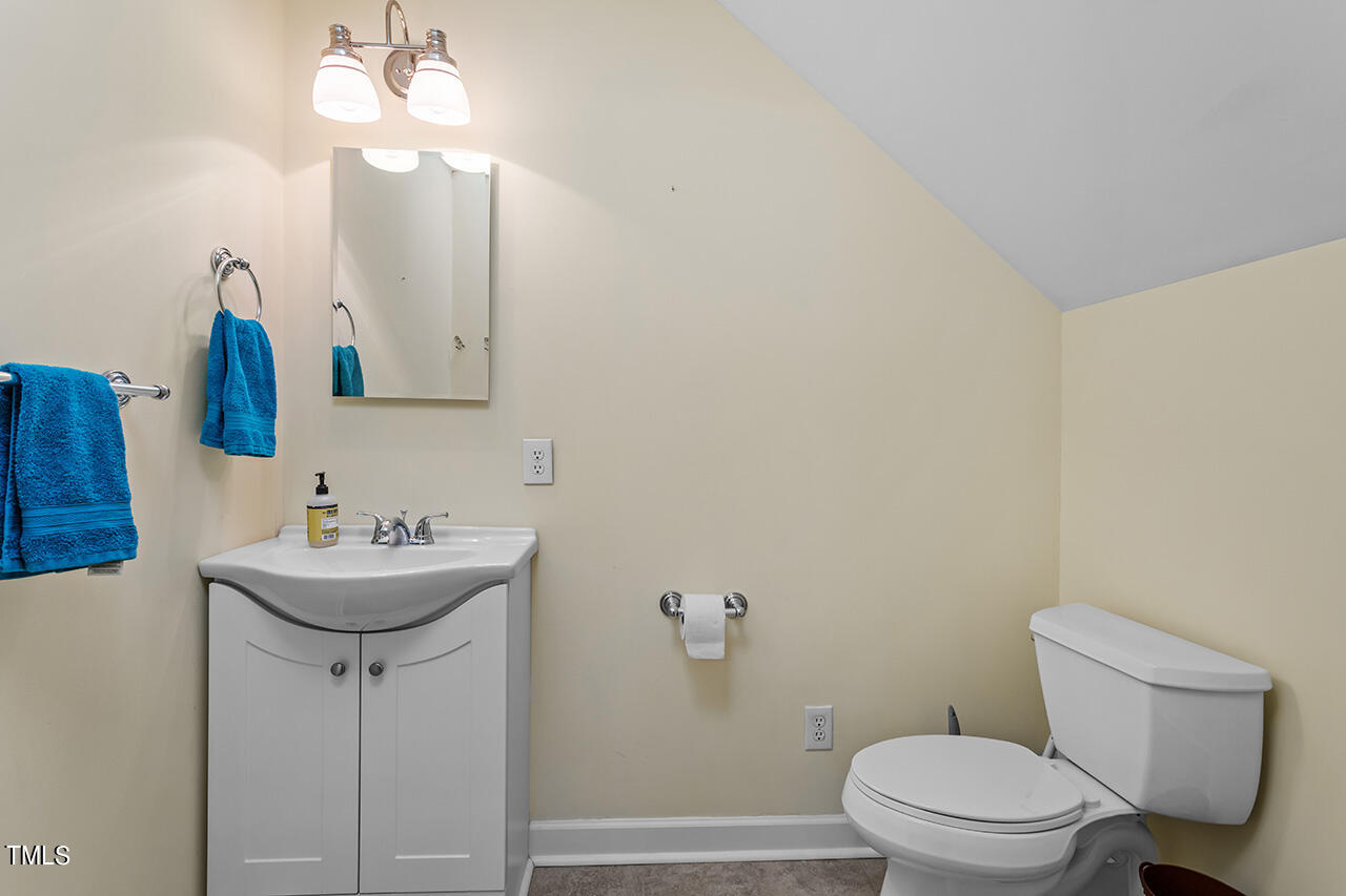 7917 Fairlake Drive Wake Forest, NC 27587 - Photo 34 of 34 a bathroom with a sink a toilet and mirror