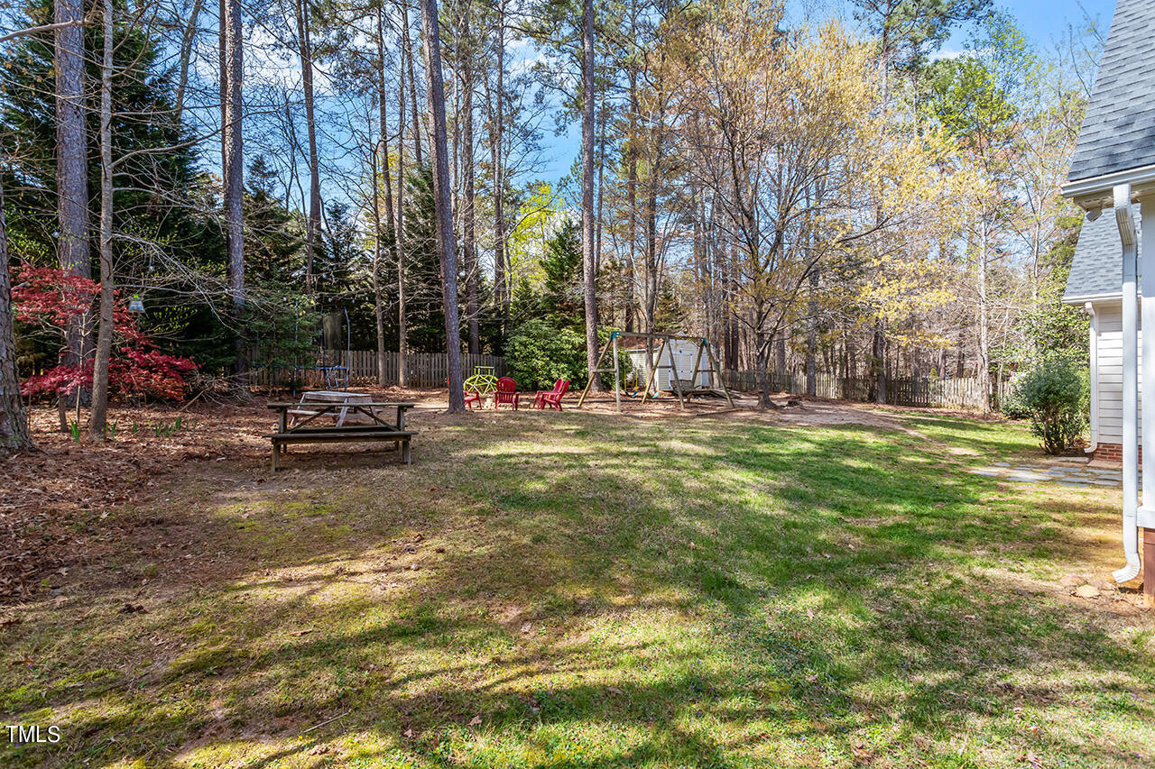 7917 Fairlake Drive Wake Forest, NC 27587 - Photo 7 of 34 a view of swimming pool with lawn chairs and plants