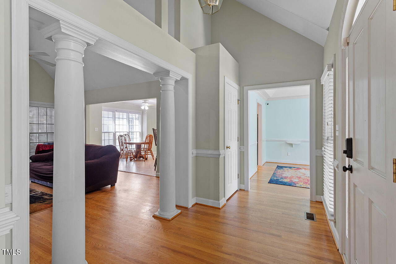 7917 Fairlake Drive Wake Forest, NC 27587 - Photo 9 of 34 a view of a hallway view with wooden floor and furniture