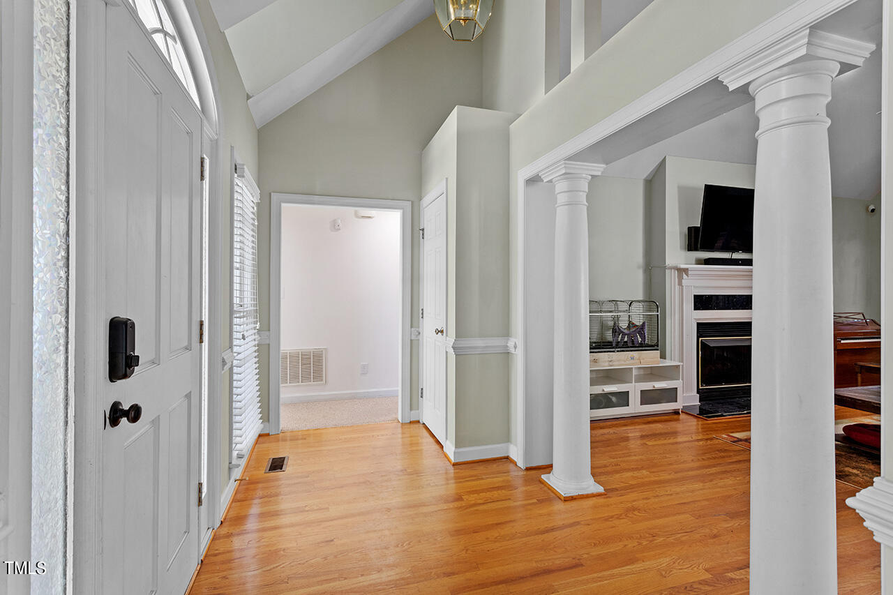 7917 Fairlake Drive Wake Forest, NC 27587 - Photo 10 of 34 a view of a hallway with wooden floor and staircase