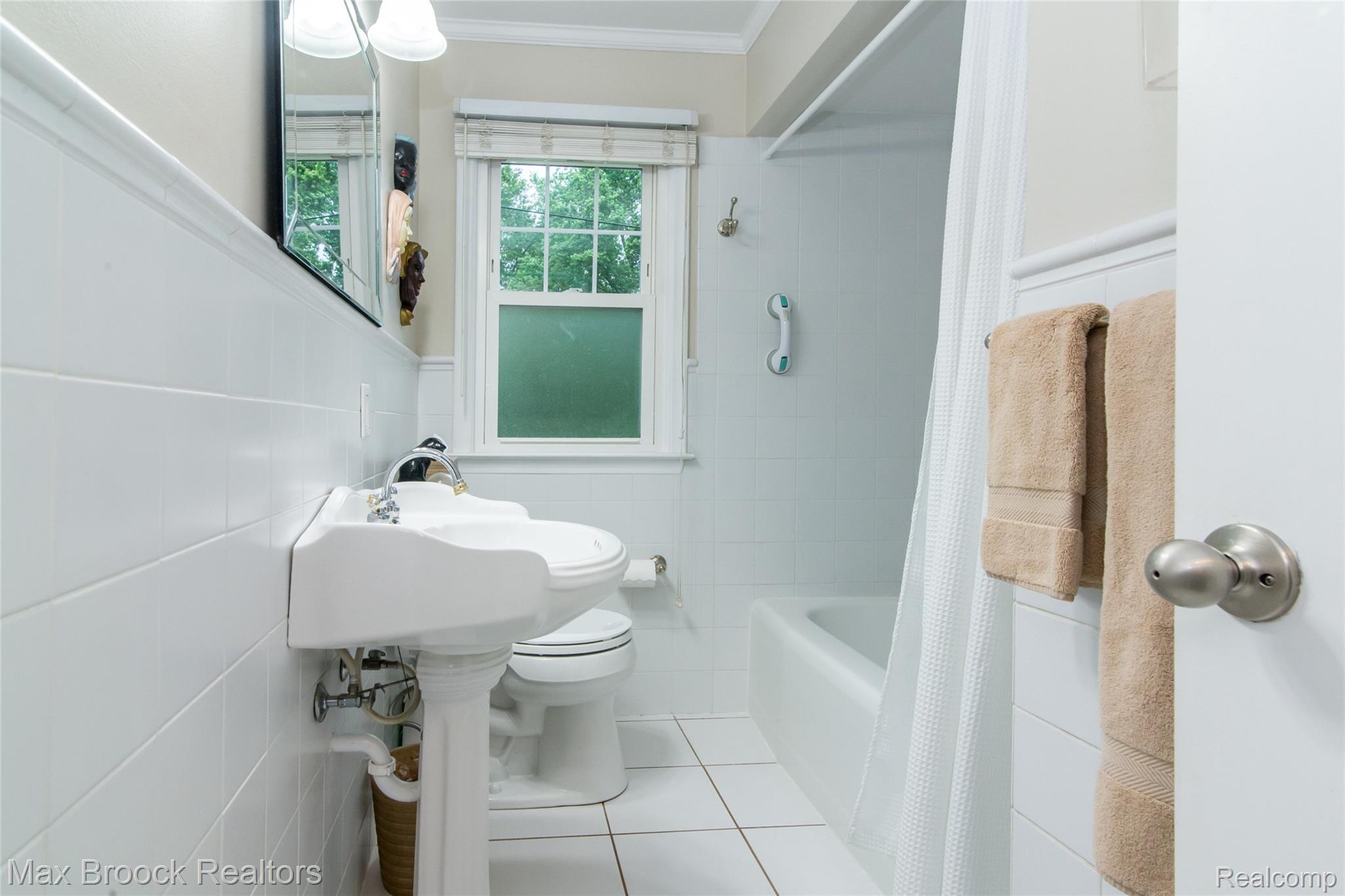 6799 East Dartmoor Road West Bloomfield, MI 48322 - Photo 18 of 36 Bathroom featuring white subway tile wainscoting, a pedestal sink, and a window with natural light