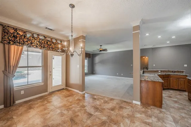 a view of a kitchen with a refrigerator and a cabinets