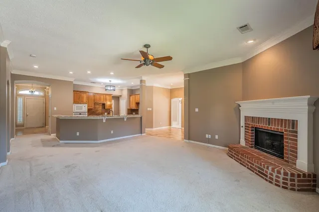 a view of a livingroom with a fireplace and a chandelier
