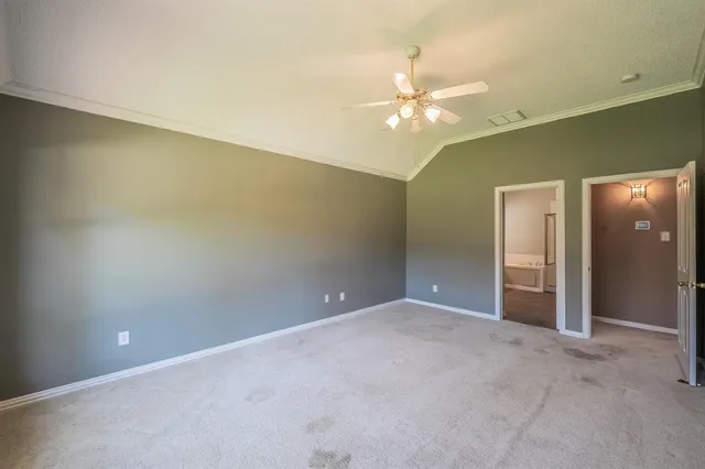 a view of an empty room with a chandelier fan