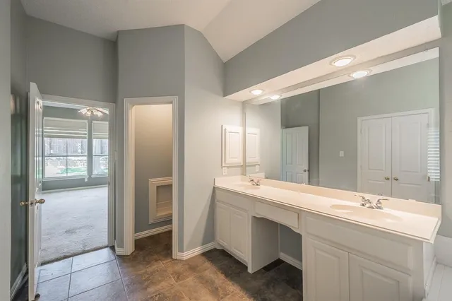 a bathroom with a double vanity sink and a mirror