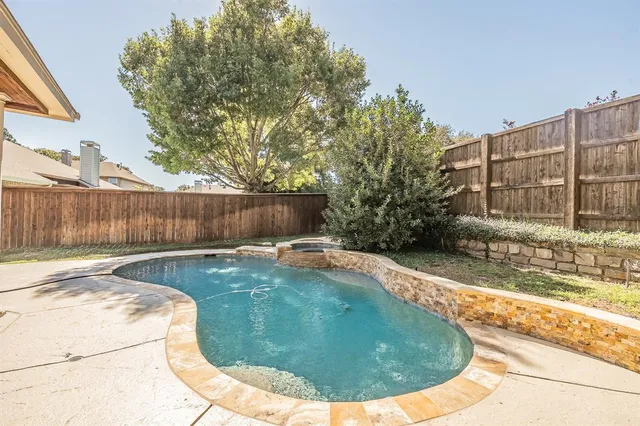 a view of a backyard with a tree