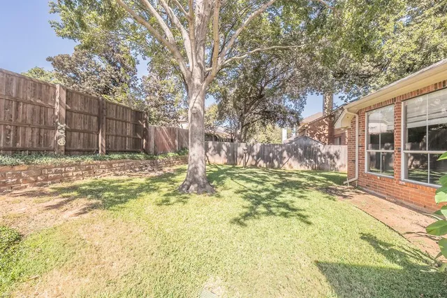 a view of a backyard with a large tree
