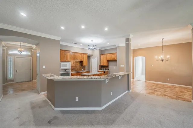 a view of kitchen with stainless steel appliances granite countertop sink