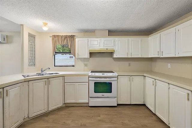 a kitchen with stainless steel appliances granite countertop a sink and a stove