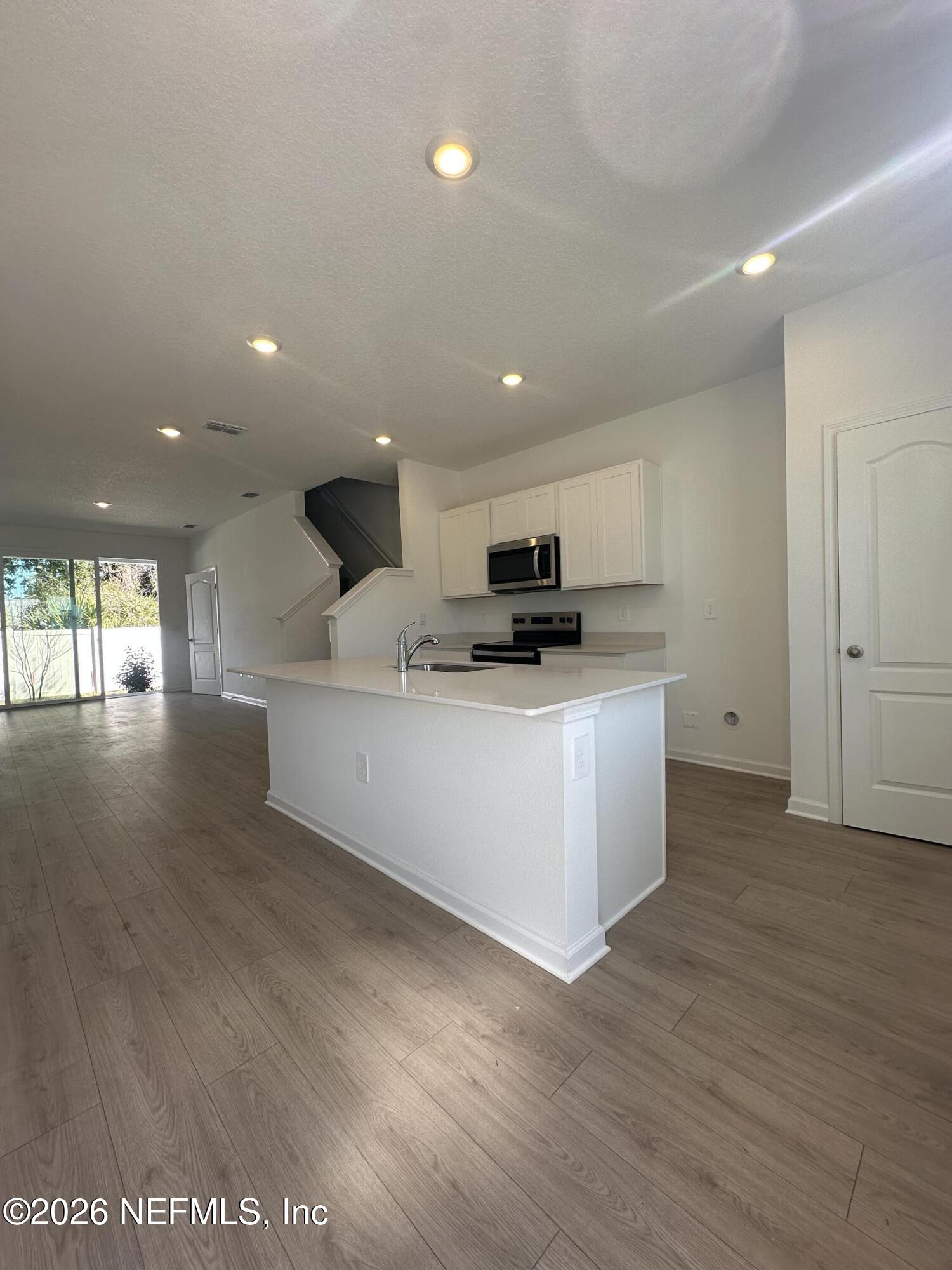 141 Palmetto Rdg Road St. Augustine, FL 32095 - Photo 9 of 43 a view of a kitchen with microwave and cabinets