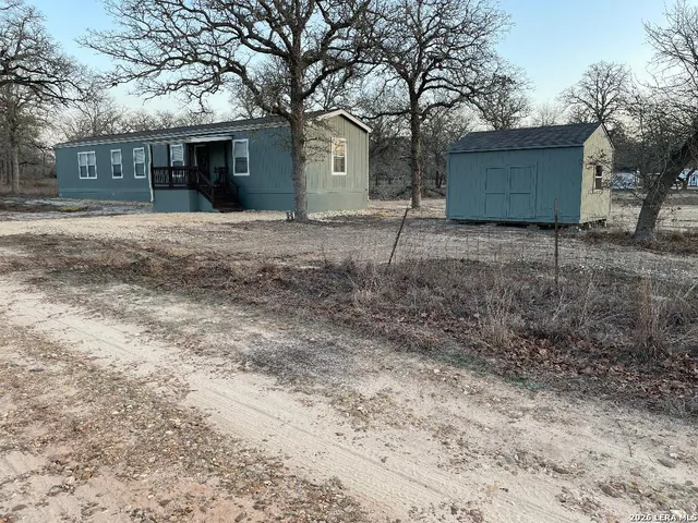a house that has a tree in front of it