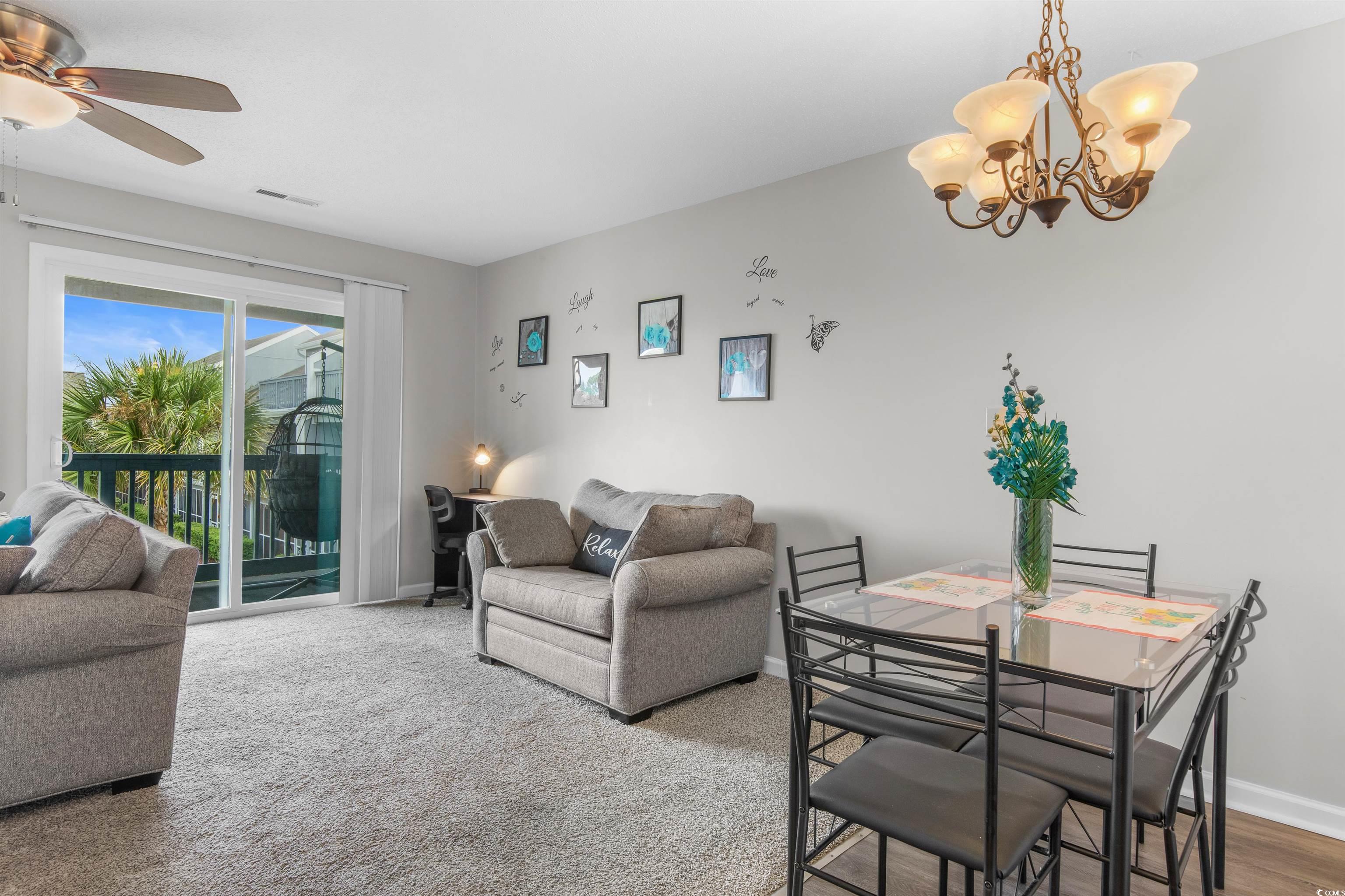 1850 Colony Drive, Unit 3D Surfside Beach, SC 29575 - Photo 17 of 38 Carpeted dining room featuring baseboards and a chandelier