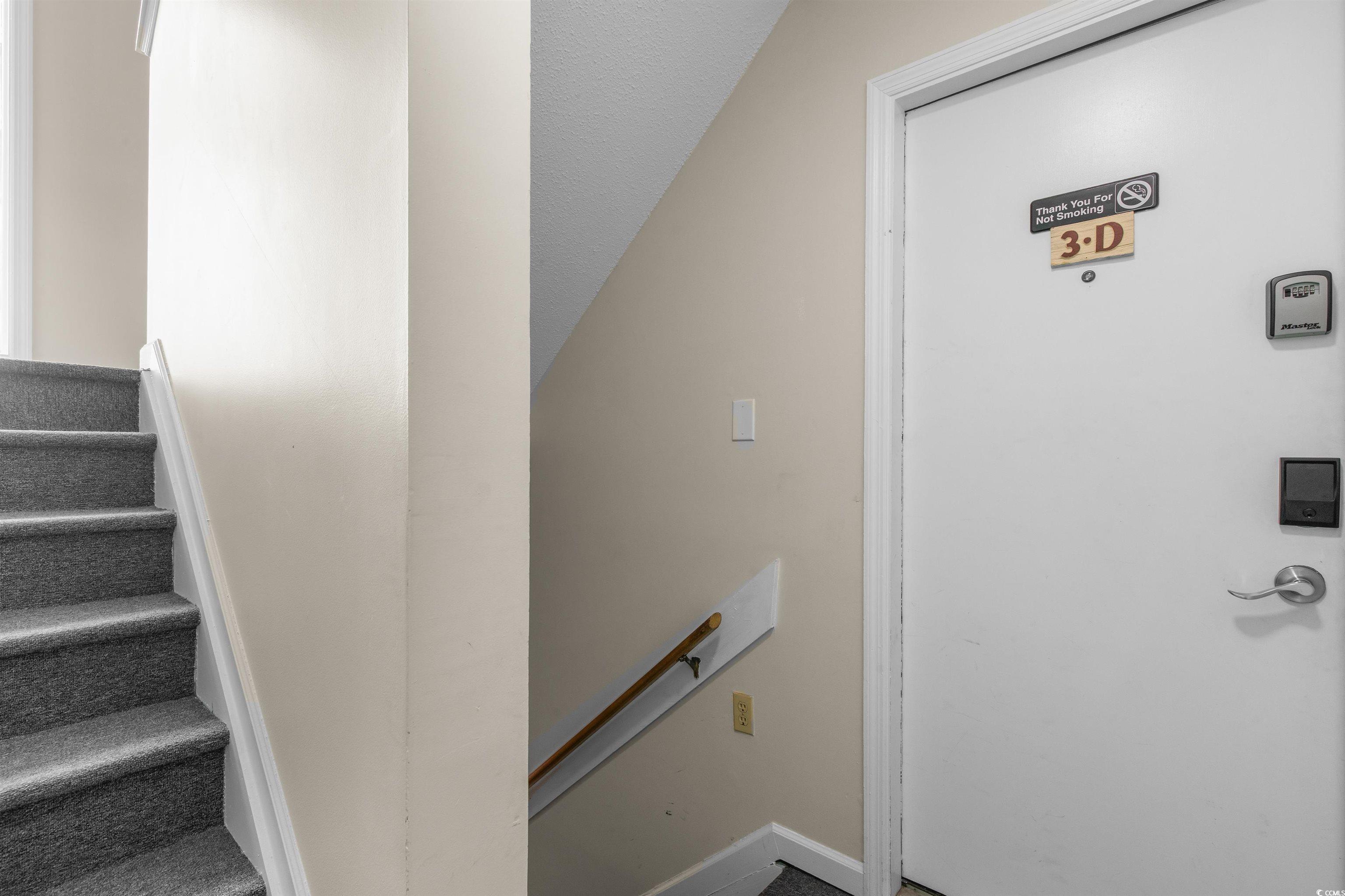 1850 Colony Drive, Unit 3D Surfside Beach, SC 29575 - Photo 2 of 38 Stairs featuring baseboards and a textured ceiling