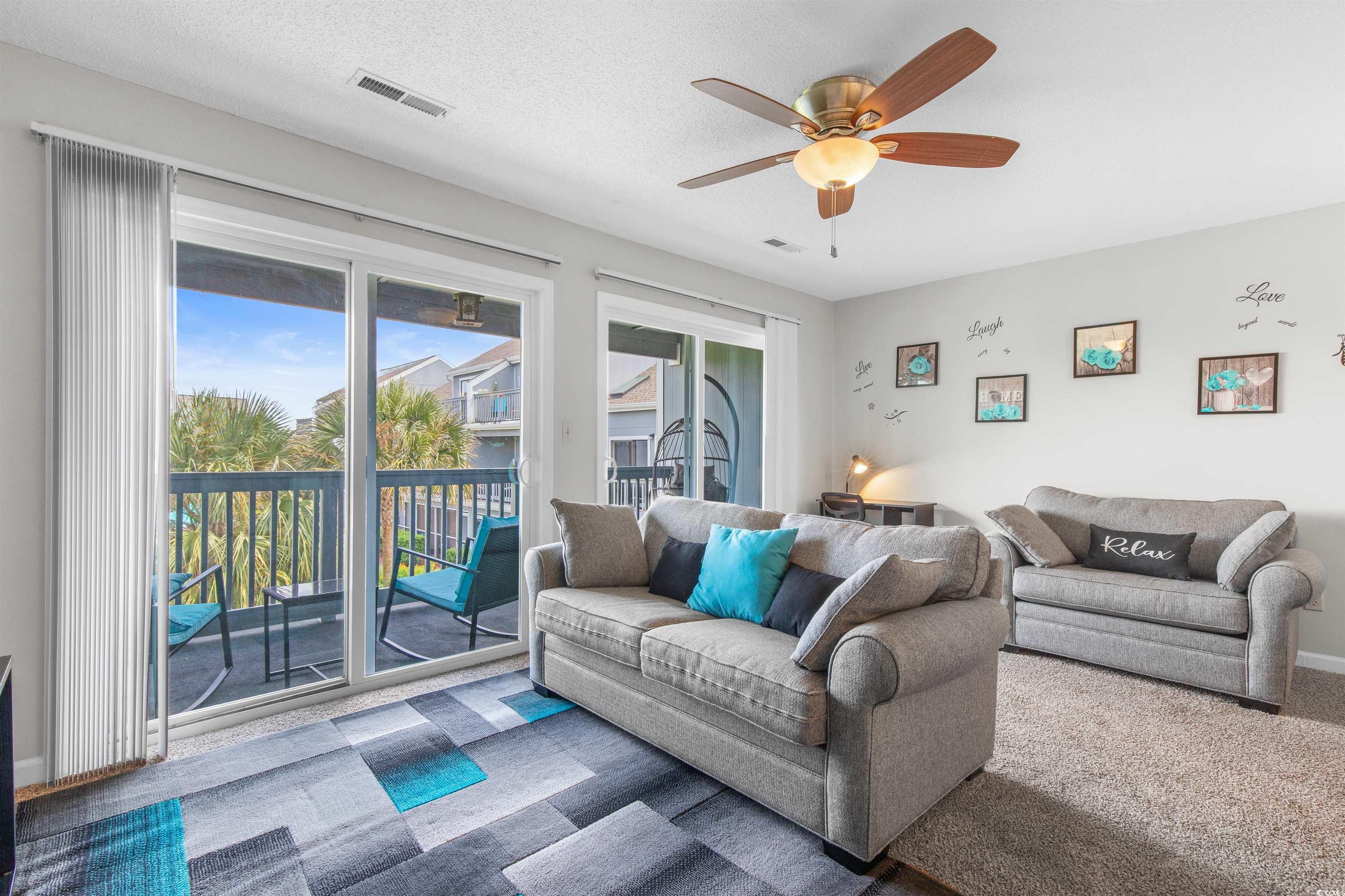 1850 Colony Drive, Unit 3D Surfside Beach, SC 29575 - Photo 19 of 38 Carpeted living area featuring ceiling fan and a textured ceiling