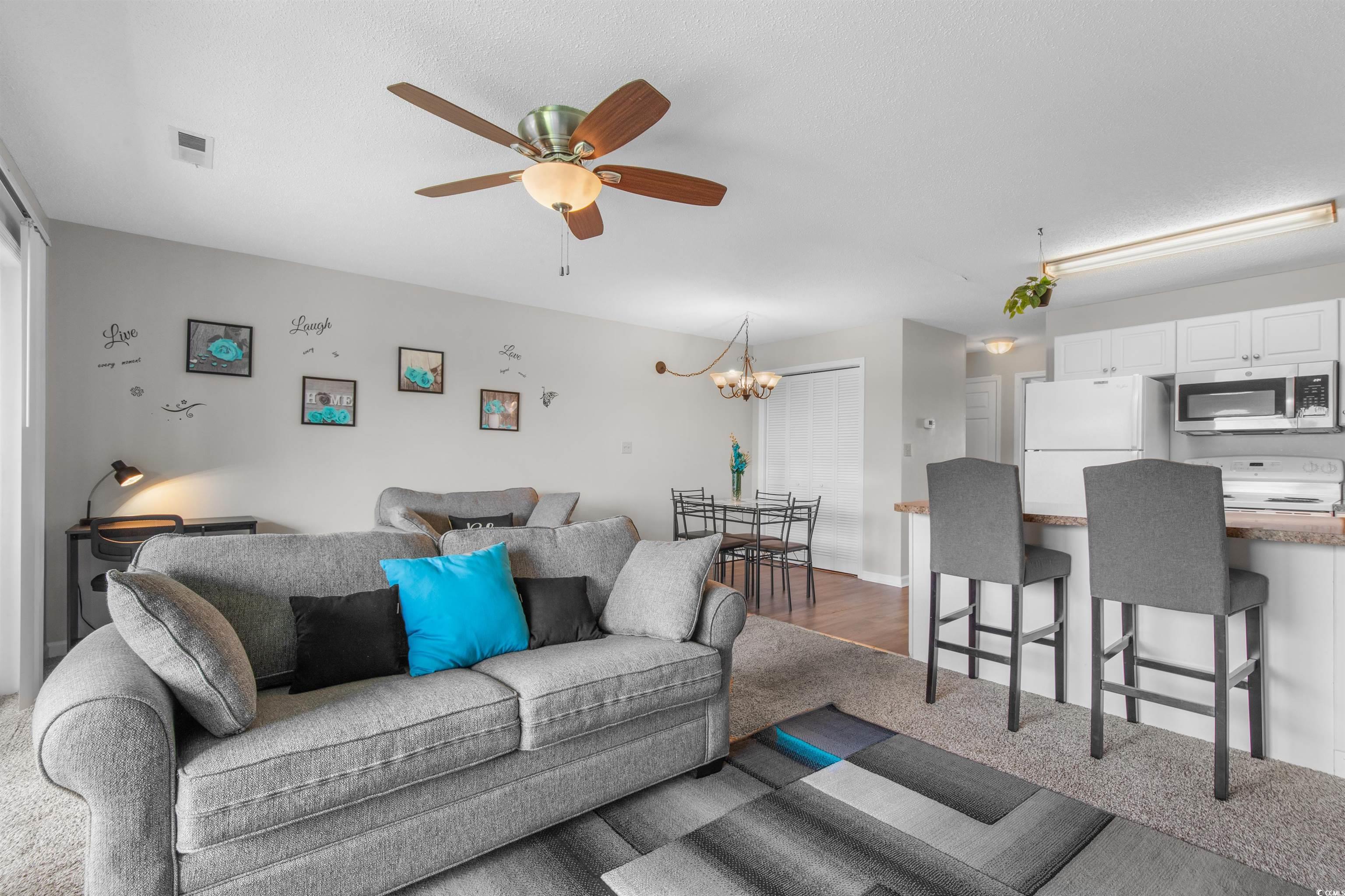 1850 Colony Drive, Unit 3D Surfside Beach, SC 29575 - Photo 20 of 38 Living room featuring a chandelier and ceiling fan