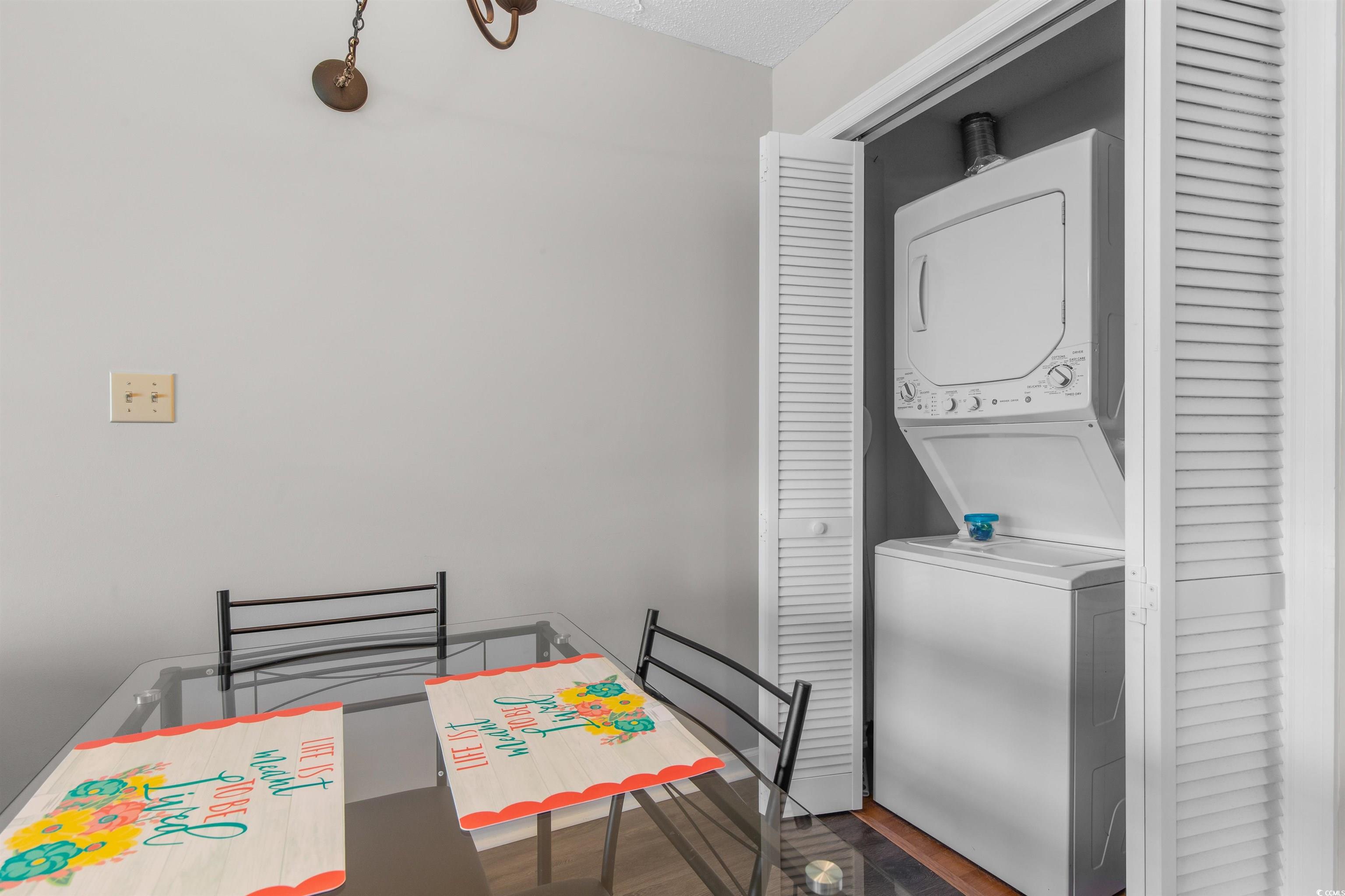 1850 Colony Drive, Unit 3D Surfside Beach, SC 29575 - Photo 23 of 38 Dining area featuring wood finished floors and estacked washer and dryer