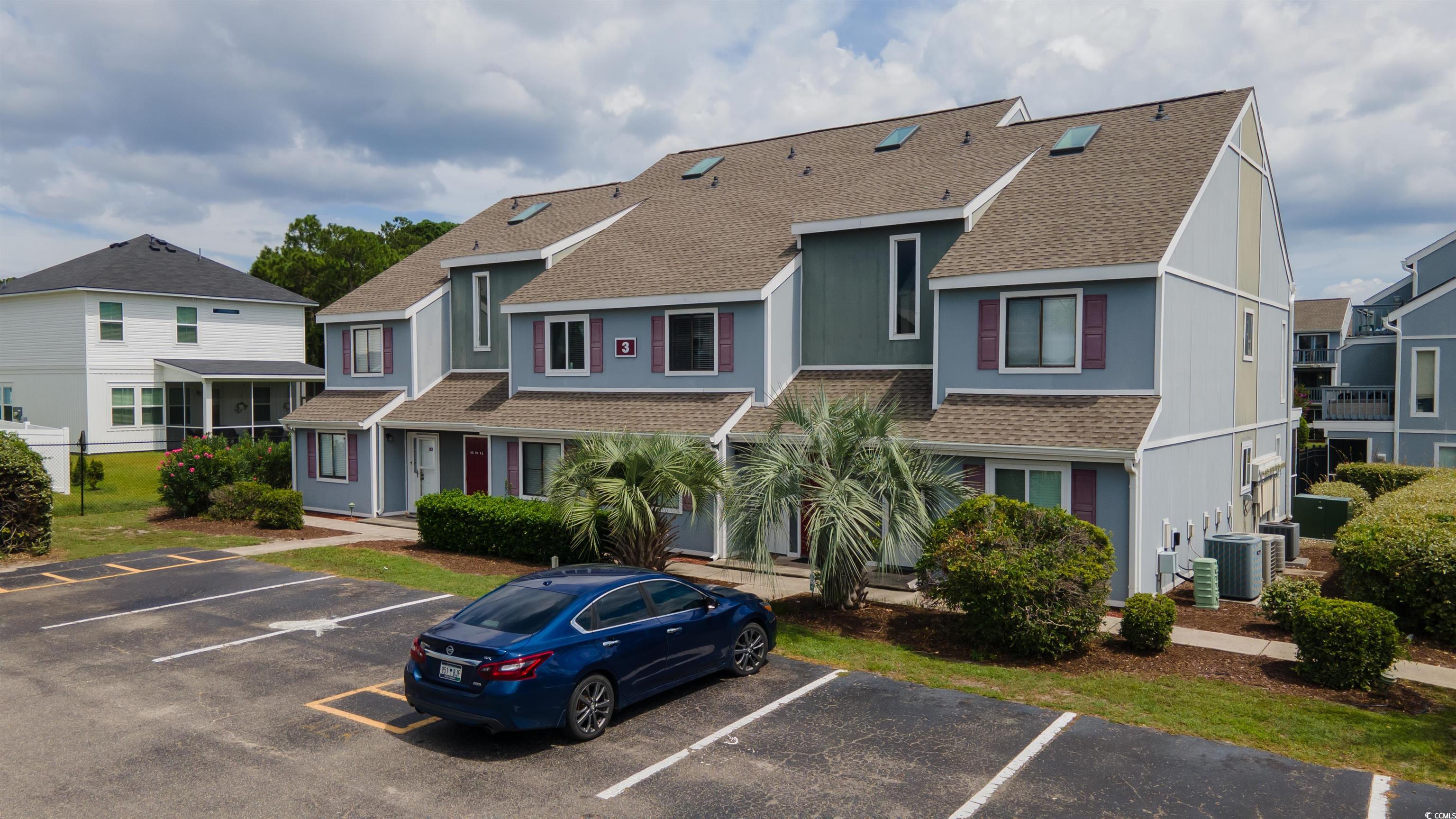 1850 Colony Drive, Unit 3D Surfside Beach, SC 29575 - Photo 27 of 38 View of building exterior featuring a residential view and uncovered parking