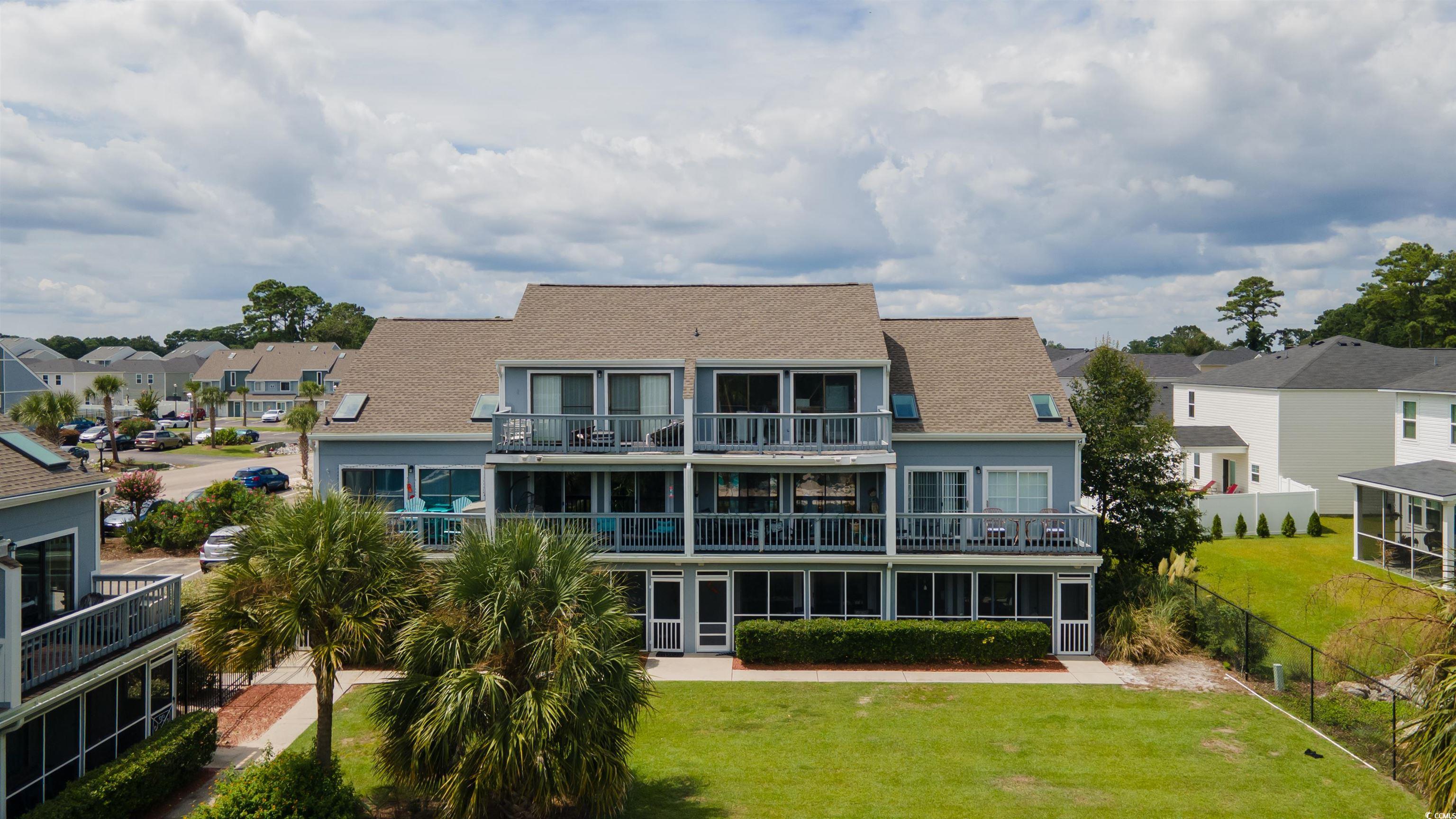 1850 Colony Drive, Unit 3D Surfside Beach, SC 29575 - Photo 36 of 38 Rear view of property with a residential view, a yard, and a balcony