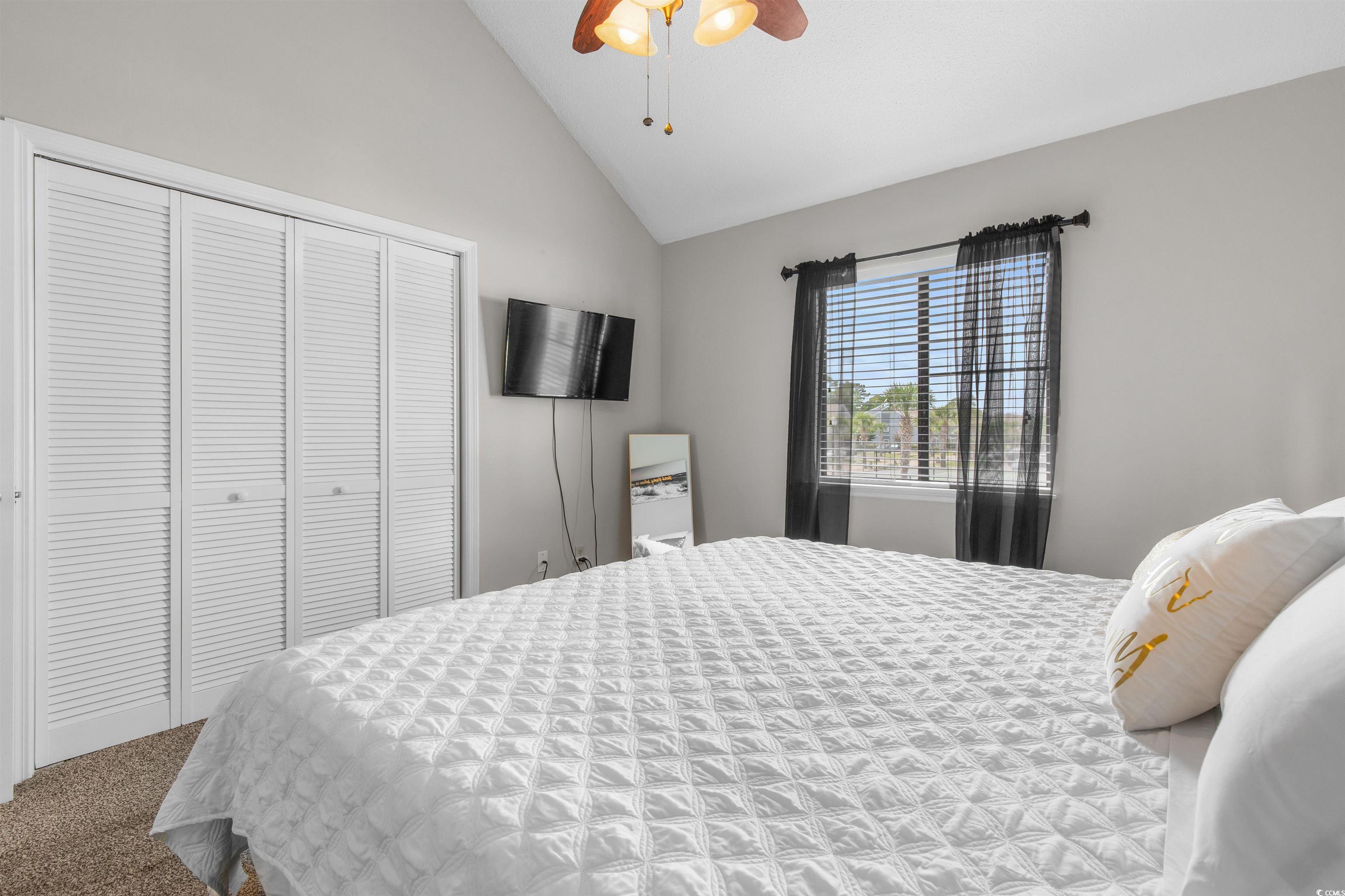 1850 Colony Drive, Unit 3D Surfside Beach, SC 29575 - Photo 4 of 38 Carpeted bedroom with a closet, ceiling fan, and high vaulted ceiling
