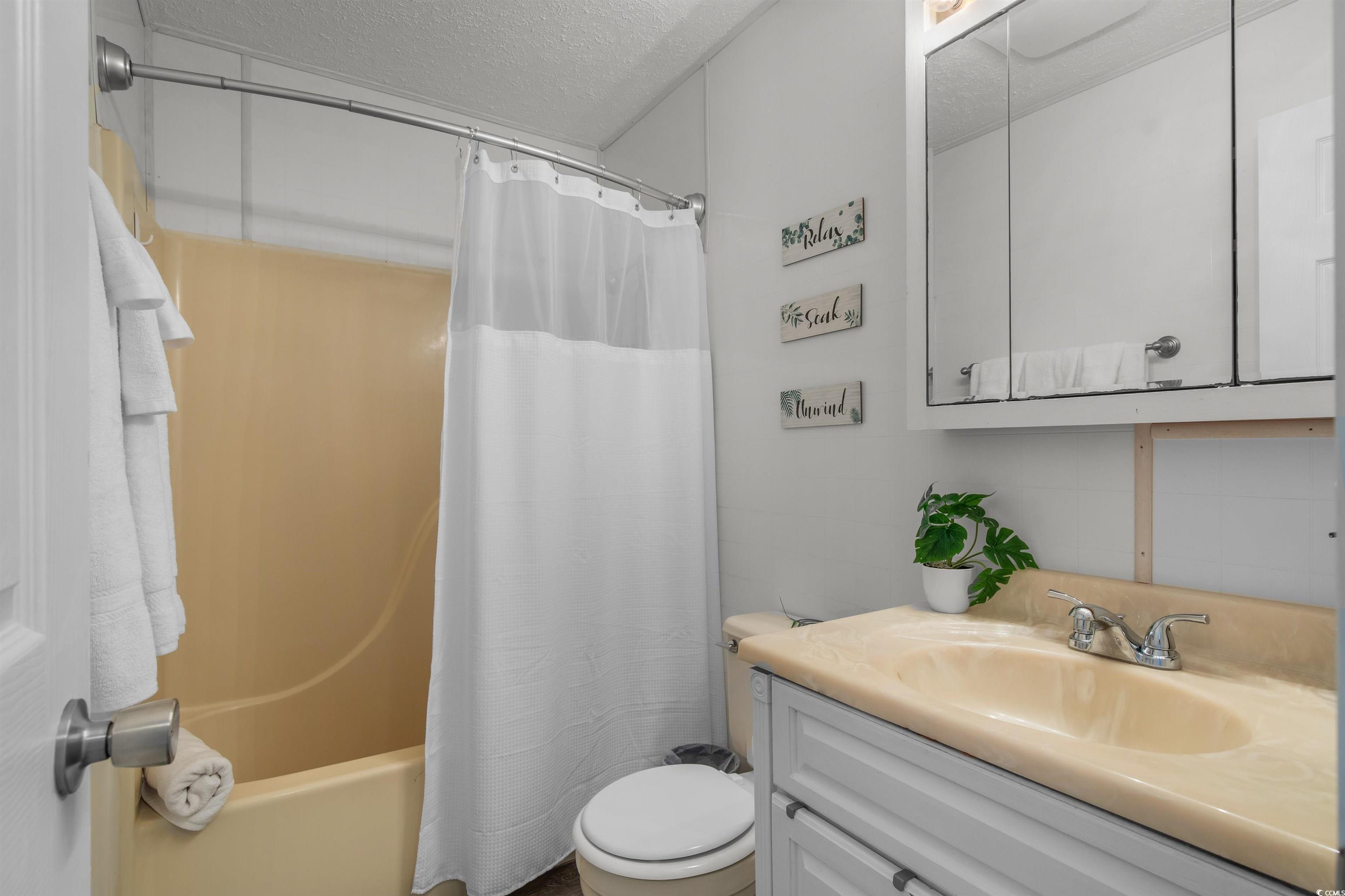 1850 Colony Drive, Unit 3D Surfside Beach, SC 29575 - Photo 9 of 38 Full bathroom featuring vanity, a textured ceiling, and shower / bath combo