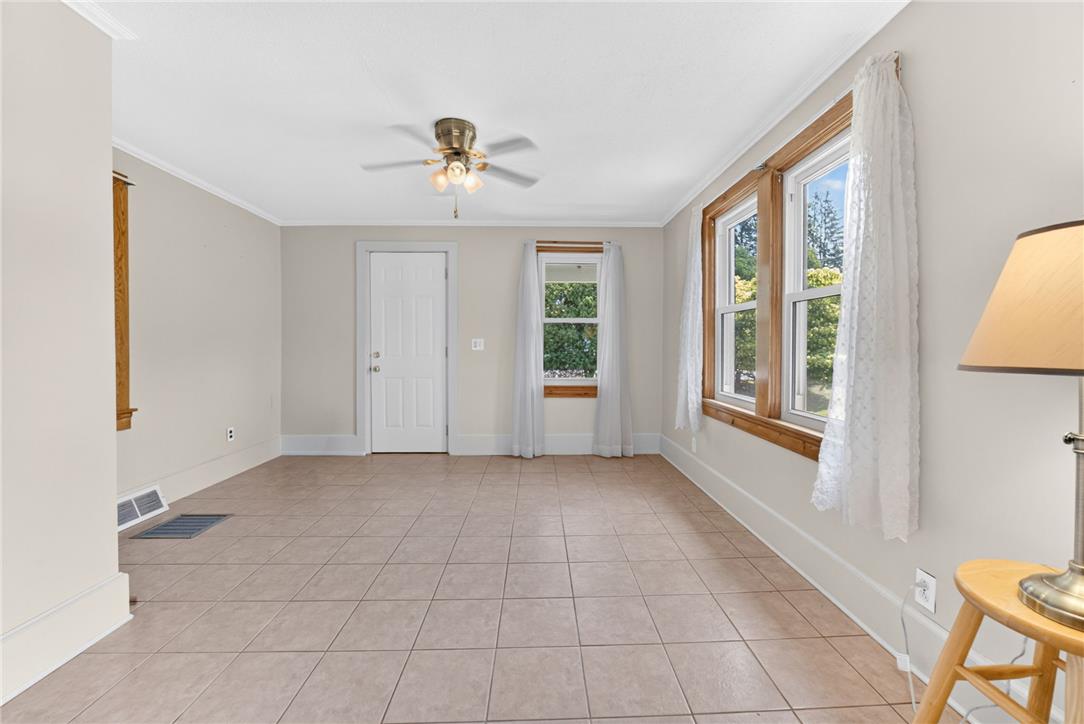1166 Stones Crossing Road Easton, PA 18045 - Photo 10 of 35 A versatile living area features durable tile flooring and multiple windows, providing ample natural light.