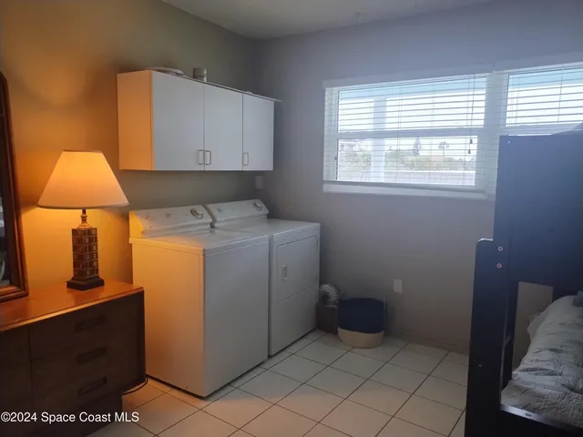 a room with a mirror on dresser and a table