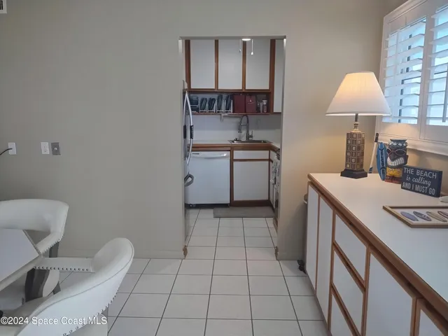 a kitchen with a sink cabinets and a stove top oven