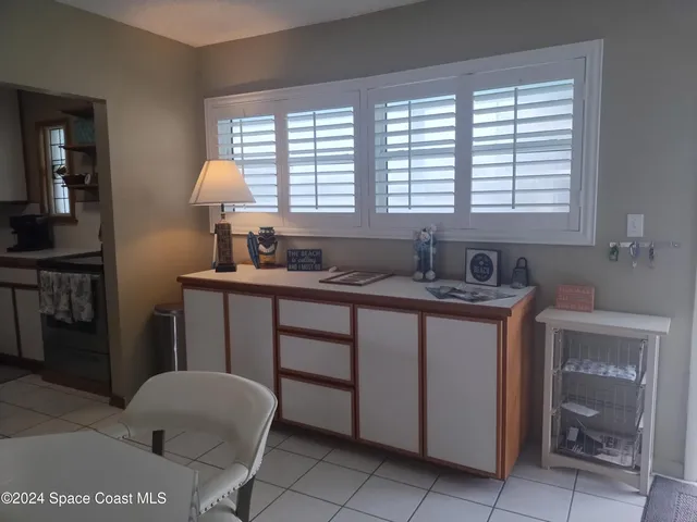a kitchen with a sink cabinets and a large window