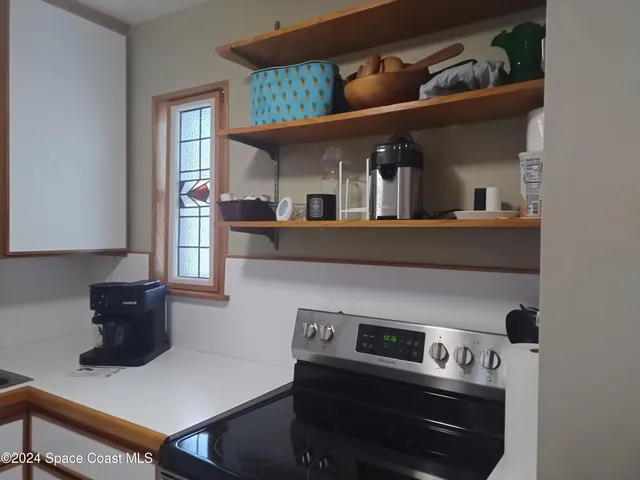 a kitchen with a stove and a refrigerator