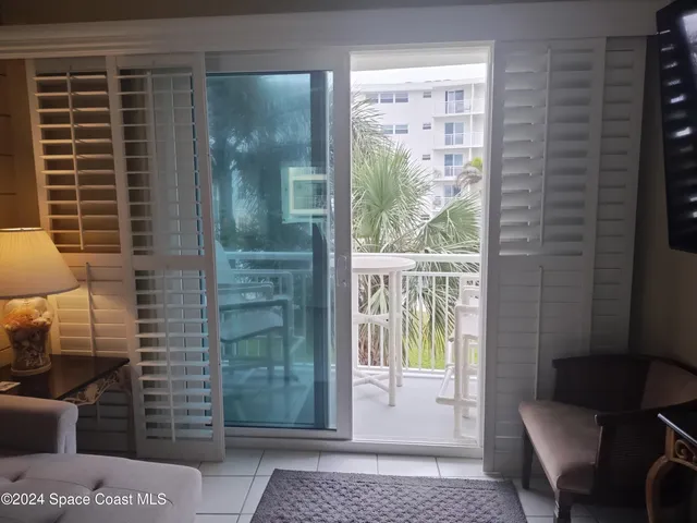 a view of a door and chair in the balcony