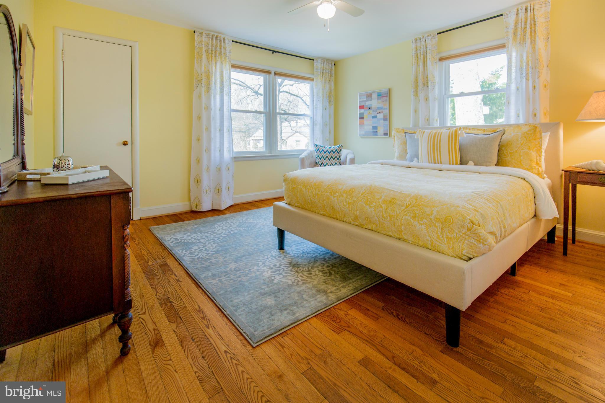 9601 Lorain Avenue Silver Spring, MD 20901 - Photo 13 of 30 a bedroom with a bed and wooden floor