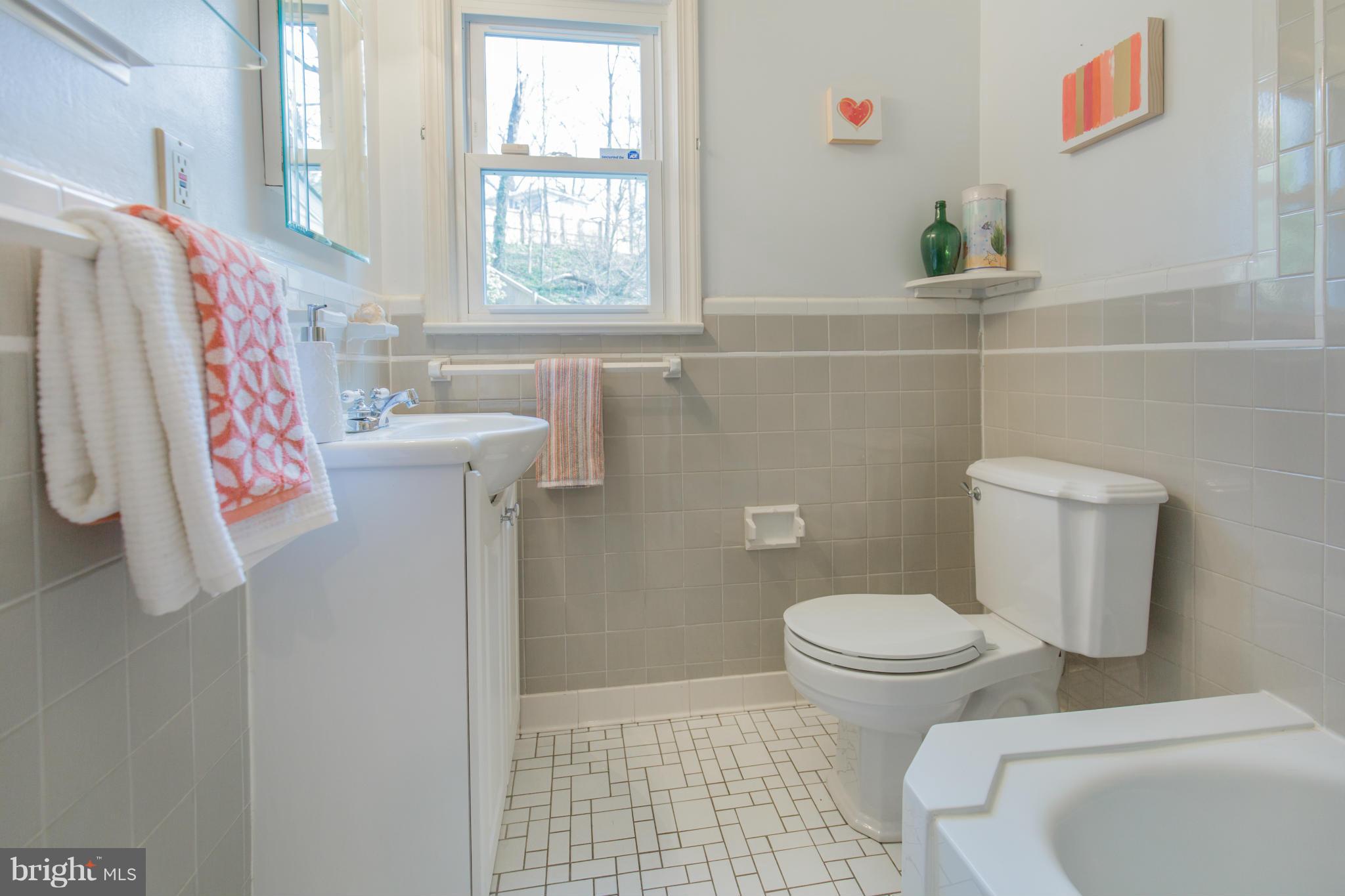 9601 Lorain Avenue Silver Spring, MD 20901 - Photo 17 of 30 a bathroom with a toilet and a shower curtain
