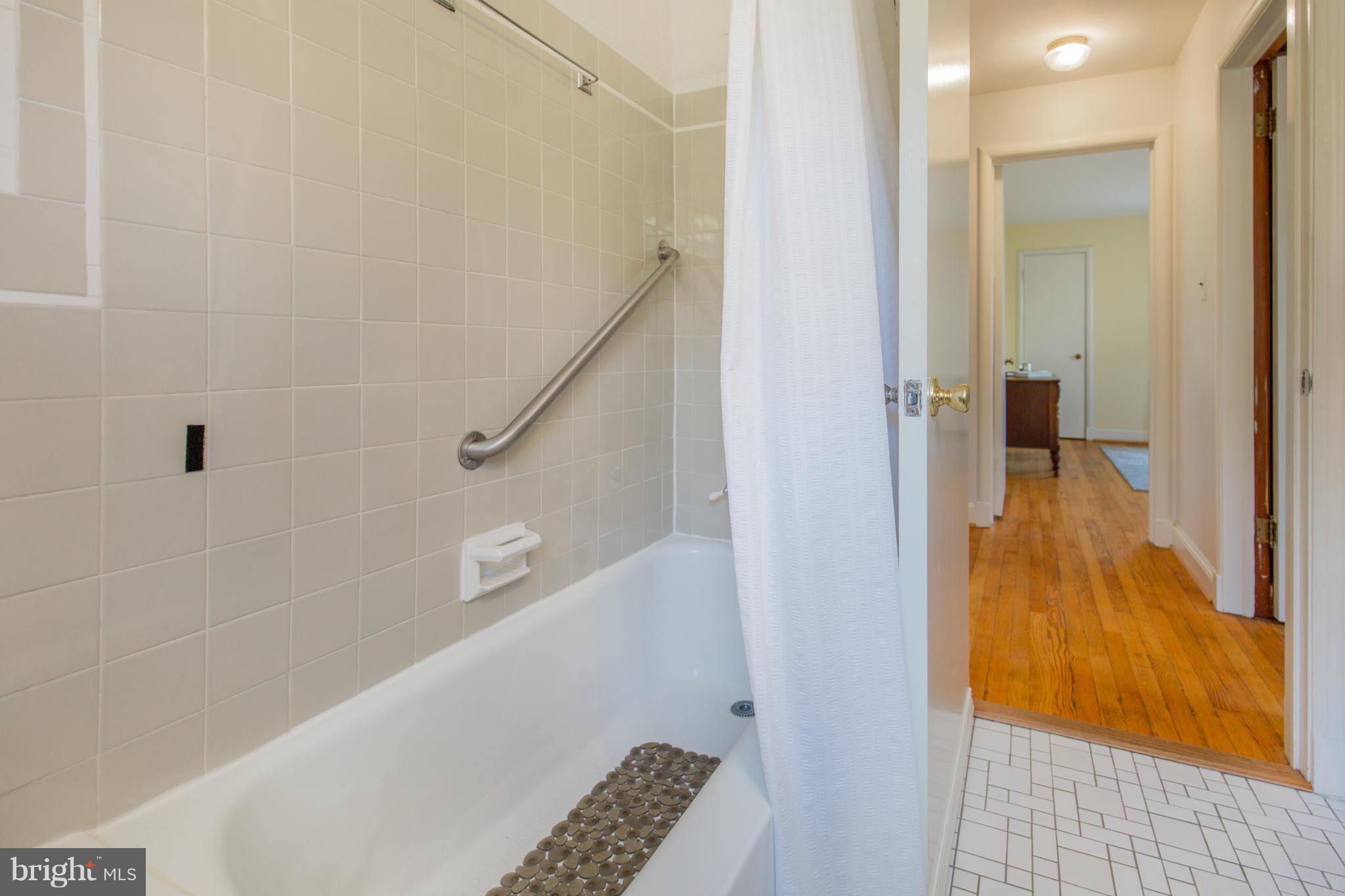 9601 Lorain Avenue Silver Spring, MD 20901 - Photo 18 of 30 a bathroom with a tub and a shower