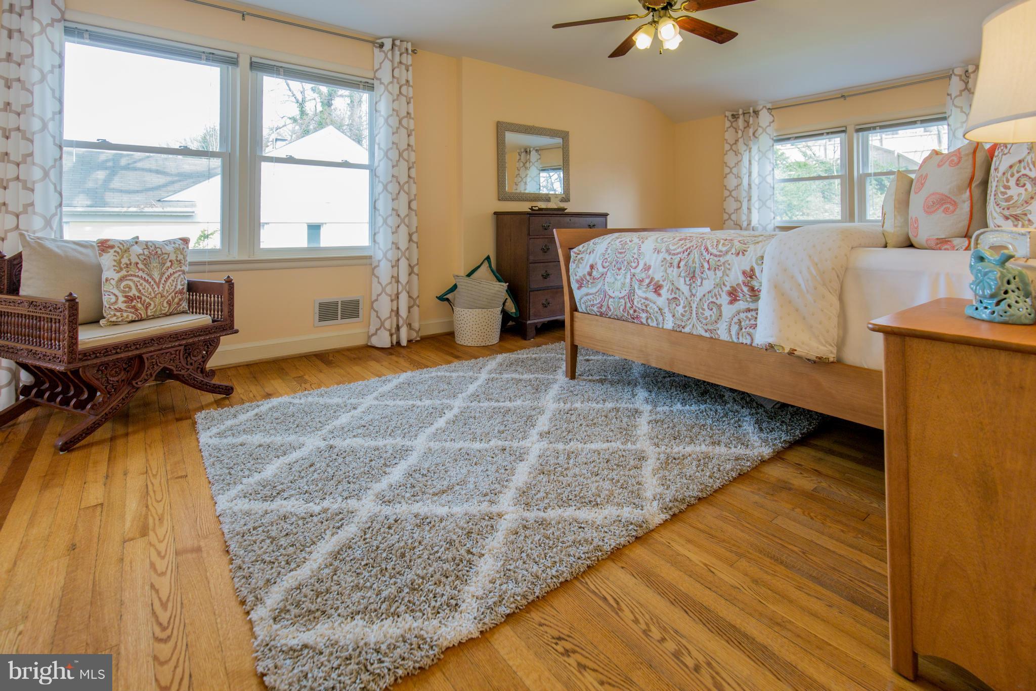 9601 Lorain Avenue Silver Spring, MD 20901 - Photo 19 of 30 a bedroom with a bed and wooden floor