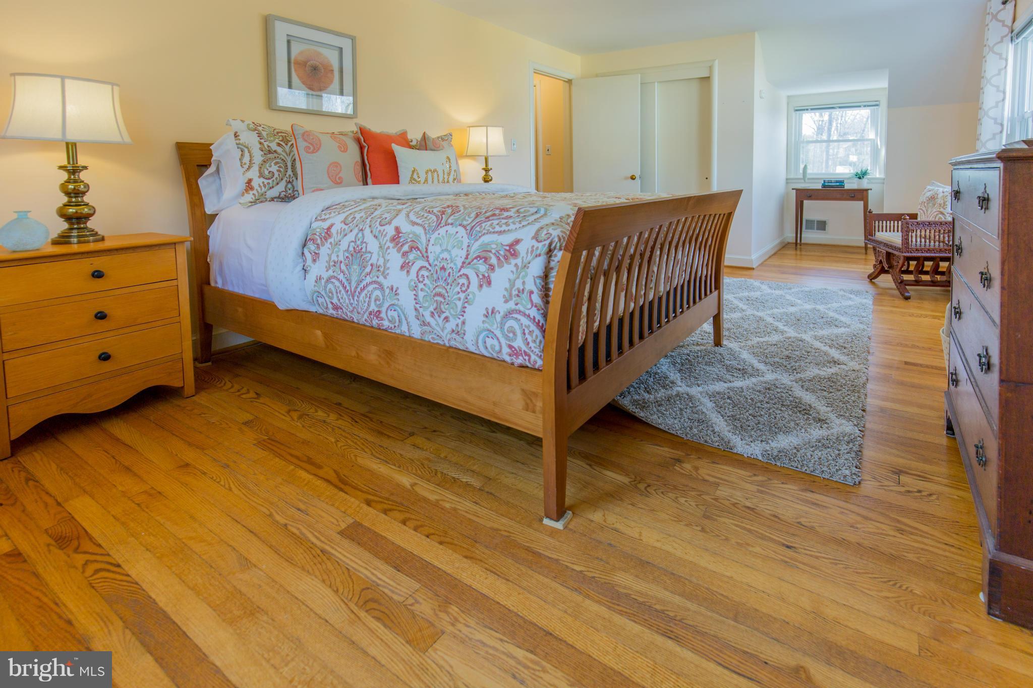 9601 Lorain Avenue Silver Spring, MD 20901 - Photo 20 of 30 a bedroom with a bed and wooden floor